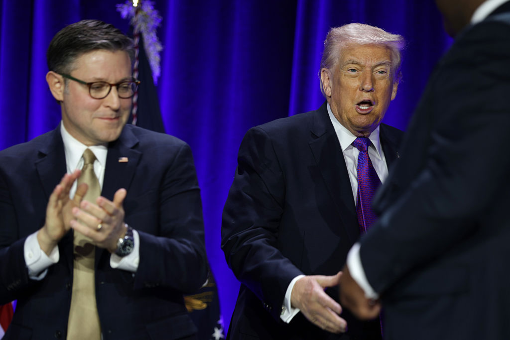 WASHINGTON, DC - FEBRUARY 05:  U.S. President Donald Trump shakes hands with Democratic Republic of the Congo President Felix Tshisekedi (R) as Speaker of the House Mike Johnson (R-LA) (L) looks on during the 74th annual National Prayer Breakfast at the Washington Hilton on February 5, 2026 in Washington, DC. President Trump is joined by bipartisan Congressional members, business, and religious leaders to pray for the nation. (Photo by Alex Wong/Getty Images)