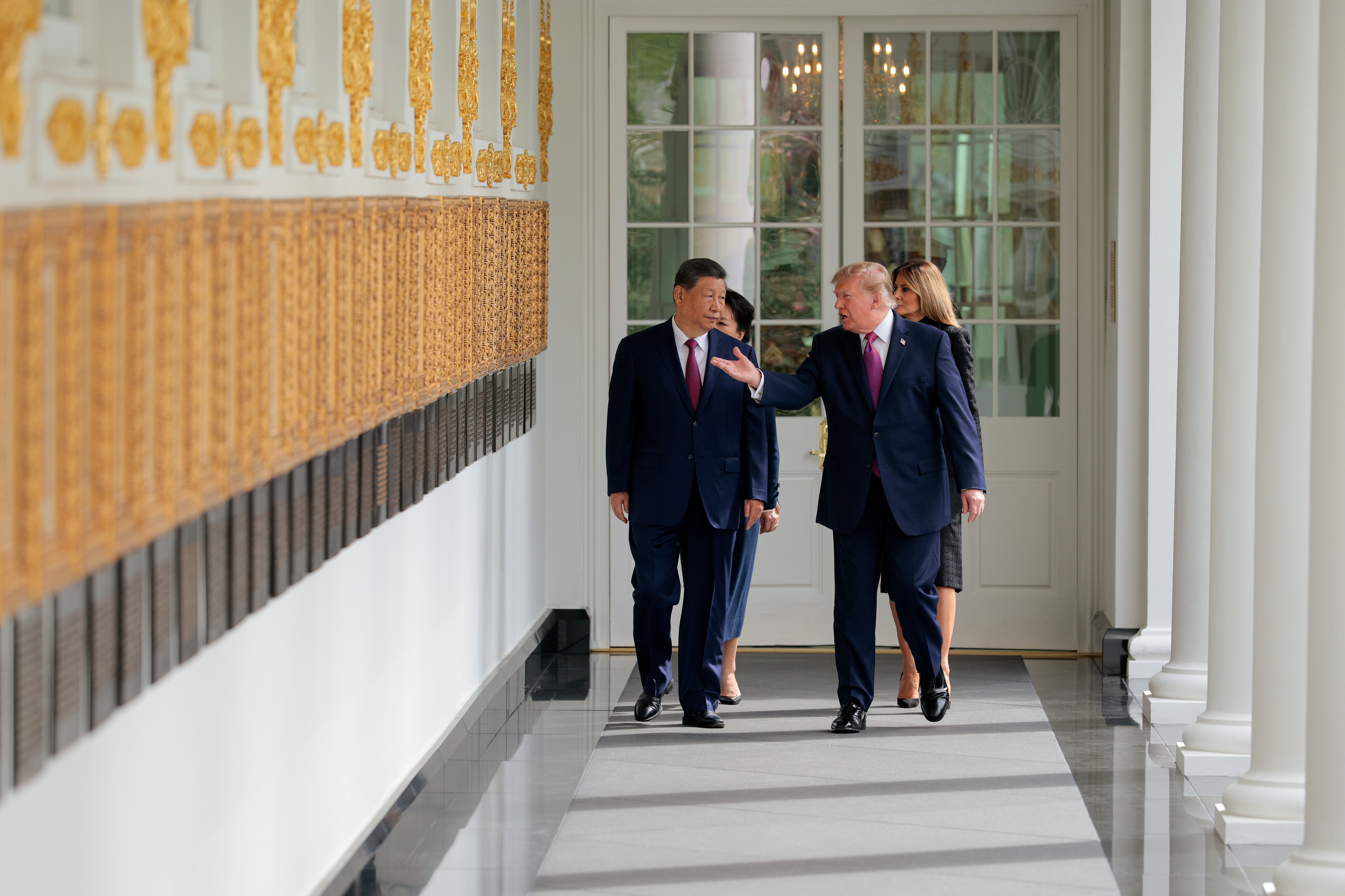 WASHINGTON, DC - SEPTEMBER 24: (L-R) President&nbsp;of&nbsp;China Xi Jinping and first lady of China Peng Liyuan walk with U.S. President Donald Trump and U.S. first lady Melania Trump along the colonade to watch a miltary review during an arrival ceremony at the White House on September 24, 2026 in Washington, DC. President Trump is hosting President Xi for a three-day state visit to Washington, DC where the leaders are expected to discuss trade practices, artificial intelligence and furthering