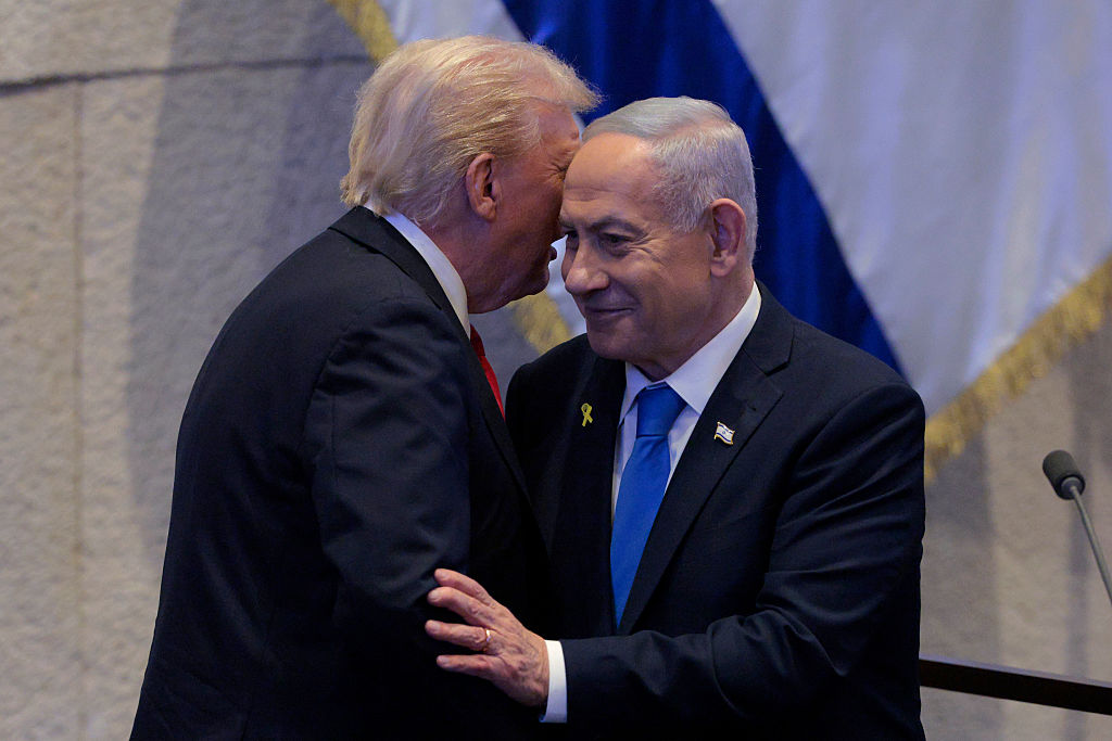 JERUSALEM - OCTOBER 13: U.S. President Donald Trump Israeli and Prime Minister Benjamin Netanyahu interact after Netanyahu addressed the Knesset on October 13, 2025 in Jerusalem. President Trump is visiting the country hours after Hamas released some of the remaining Israeli hostages captured on Oct. 7, 2023, part of a US-brokered ceasefire deal to end the war in the Gaza Strip.  (Photo by Chip Somodevilla/Getty Images)