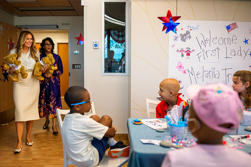 WASHINGTON, DC - JULY 3: First lady Melania Trump, accompanied by Children's National Hospital President and CEO Michelle Riley-Brown (2nd-L) visits with children at Children's National Hospital on July 3, 2025 in Washington, DC. Melania Trump visited the hospital the day before the July 4th holiday to greet patients, participate in arts and crafts, see a hybrid tea rose bush planted from the White House in the hospital's Bunny Mellon Healing Garden, and visit with a 3-month old transplant patient and his family. (Photo by Andrew Harnik/Getty Images)