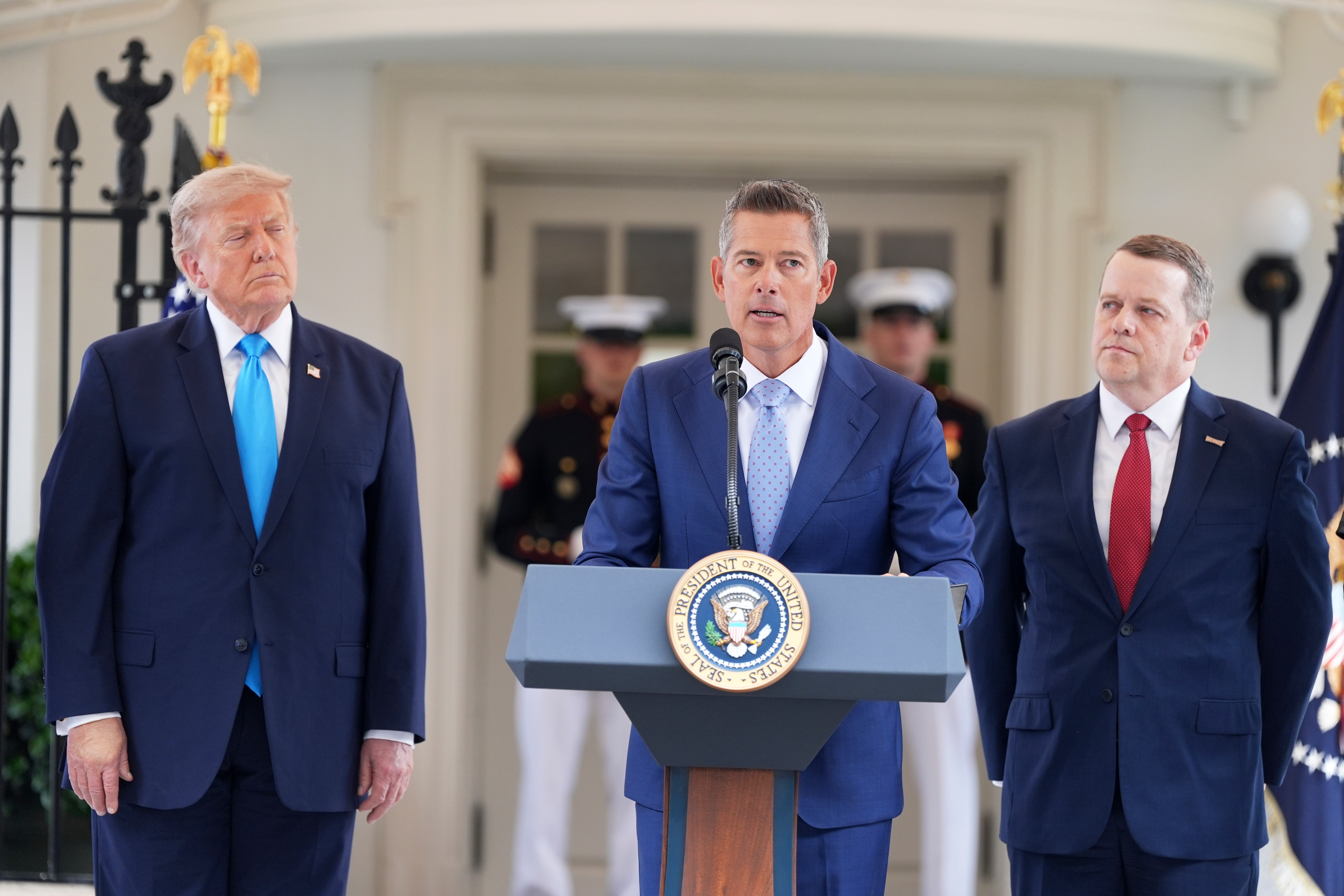 Transportation Secretary Sean Duffy speaks alongside President Donald Trump, left, and Werner Enterprises President Nathan J. Meisgeier during an event to announce the Freedom Haulers initiative at the White House, Thursday, July 30, 2026, in Washington. (AP Photo/Alex Brandon)