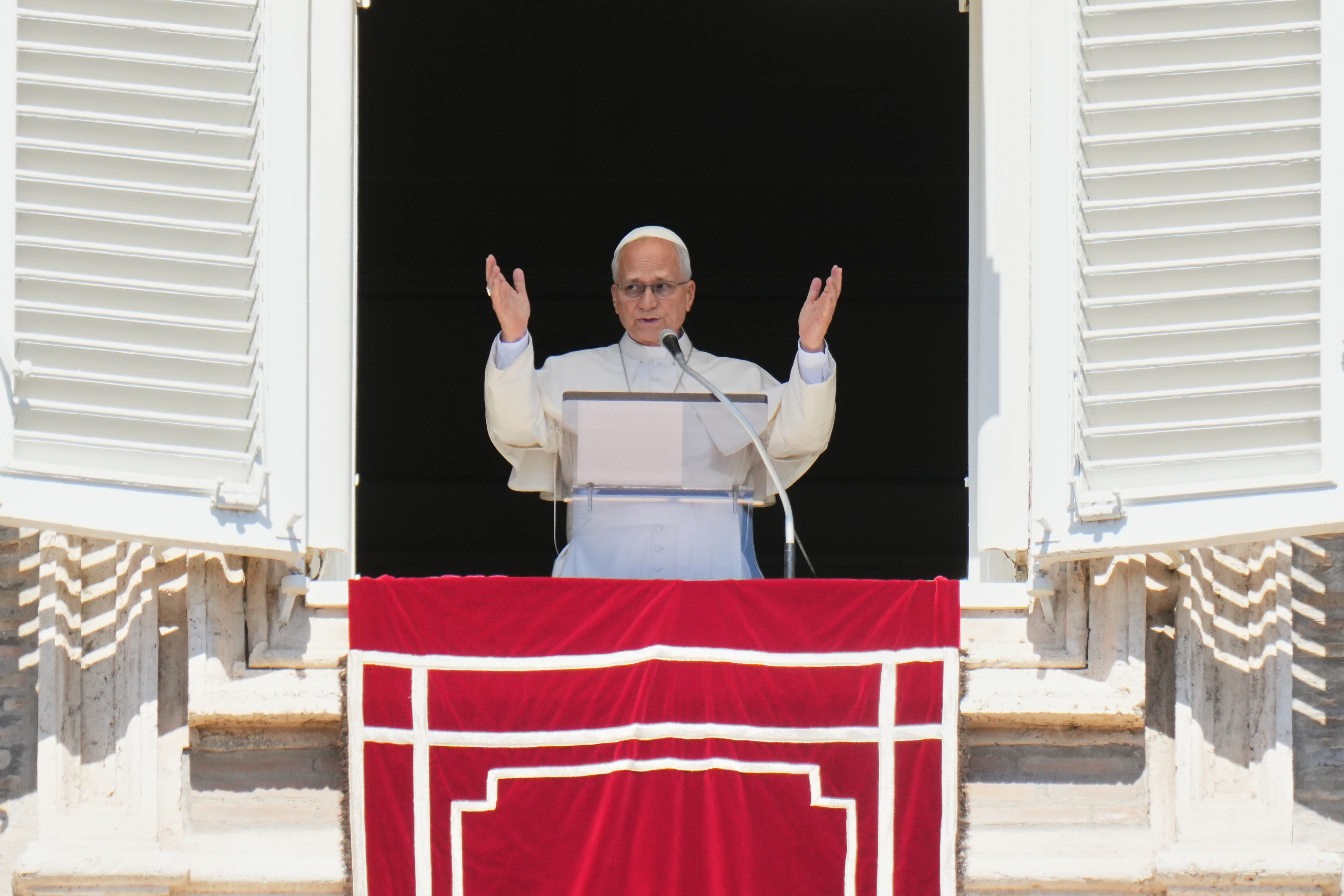 Pope Leo XIV blesses faithful during the Angelus noon prayer from the window of his studio overlooking St.Peter's Square, at the Vatican, Sunday, Sept. 13, 2026. (AP Photo/Alessandra Tarantino)