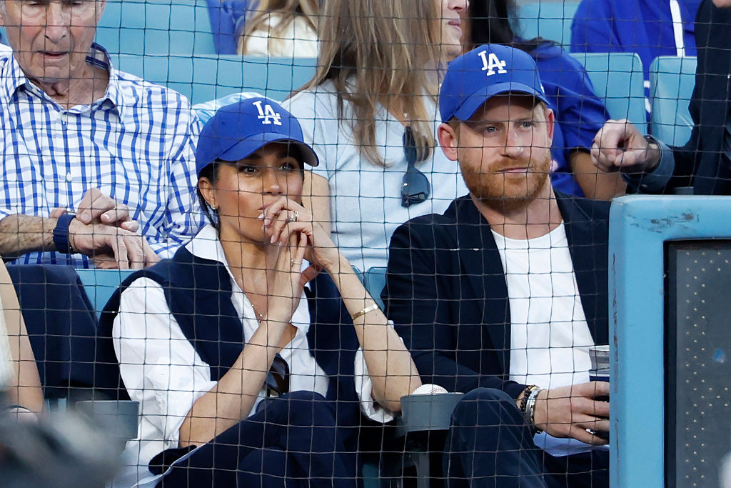 LOS ANGELES, CALIFORNIA - OCTOBER 28: Prince Harry, Duke of Sussex and Meghan, Duchess of Sussex look on from the stands during game four of the 2025 World Series between the Toronto Blue Jays and the Los Angeles Dodgers at Dodger Stadium on October 28, 2025 in Los Angeles, California. (Photo by Ronald Martinez/Getty Images)