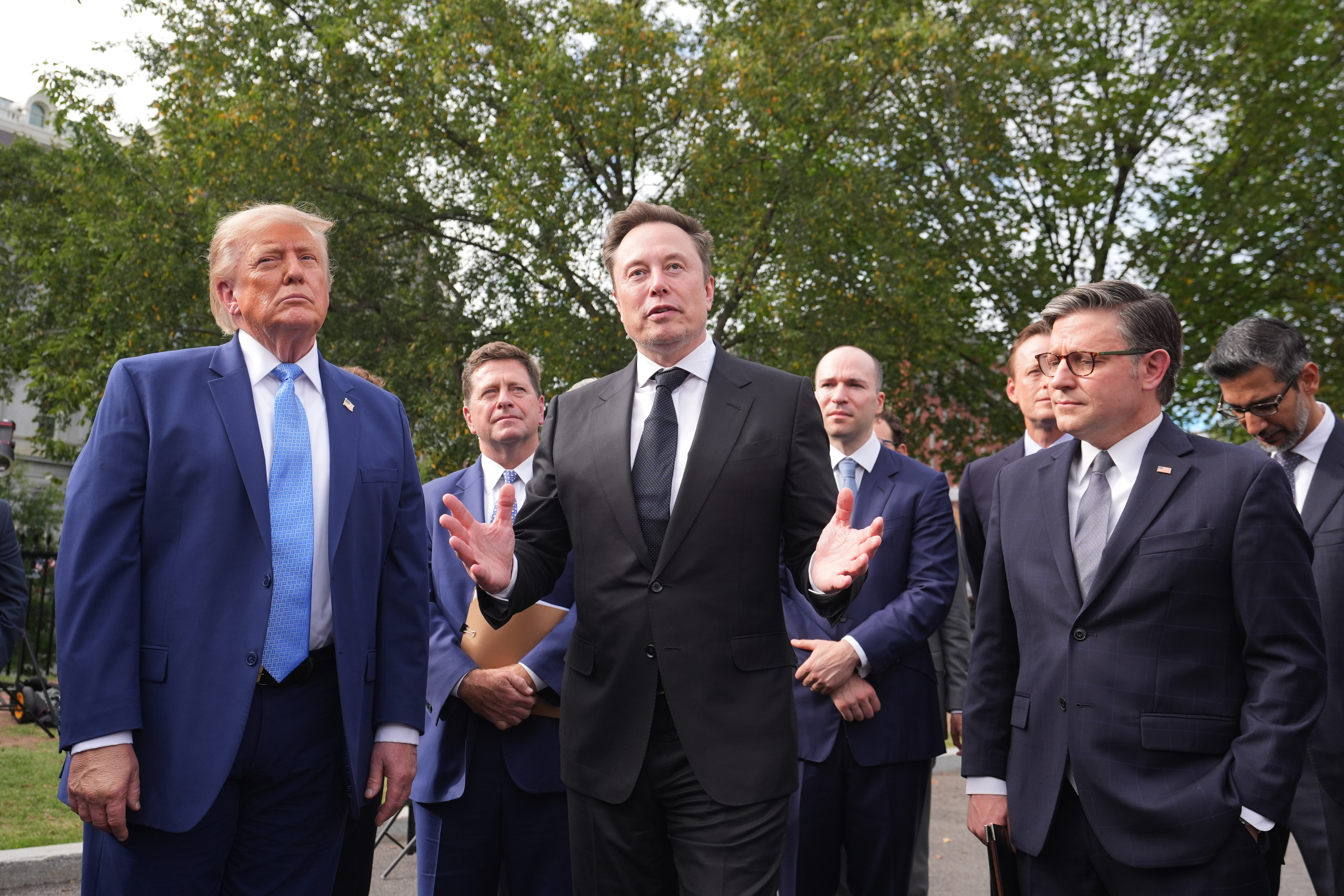 President Donald Trump listens as Elon Musk speaks to reporters at the White House in Washington, Tuesday Sept. 29, 2026, after meeting with top executives of AI firms. At right is House Speaker Mike Johnson of La. (AP Photo/Alex Brandon)