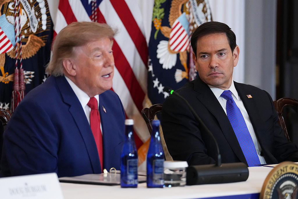 WASHINGTON, DC - AUGUST 07: U.S. Secretary of State Marco Rubio (R) listens as U.S. President Donald Trump speaks during a roundtable on the American mining industry at the U.S. Department of State on August 07, 2026 in Washington, DC. Trump attended the event as his administration aims to secure additional supplies of critical minerals in an effort to replenish weapons stockpiles&nbsp;that have been depleted during the U.S. conflict with Iran.  (Photo by Eric Lee/Getty Images)