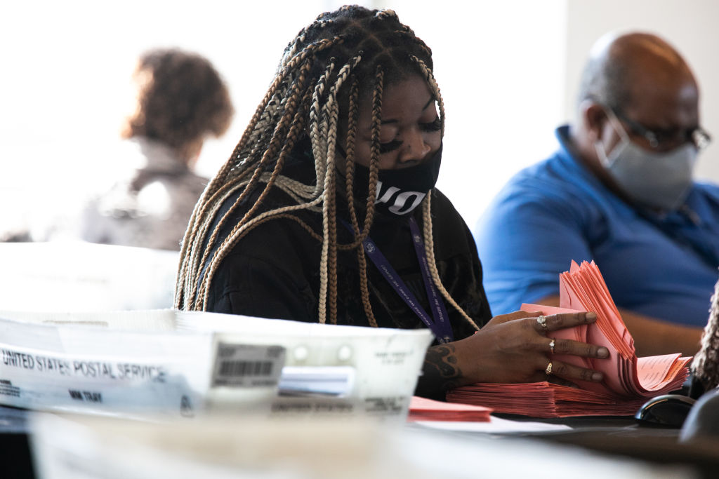 ATLANTA, GA - NOVEMBER 06: A Fulton county worker continue to count absentee ballots at State Farm Arena on November 6, 2020 in Atlanta, Georgia. The 2020 presidential race between incumbent U.S. President Donald Trump and Democratic nominee Joe Biden is still too close to call with outstanding ballots in a number of states including Georgia. (Photo by Jessica McGowan/Getty Images)