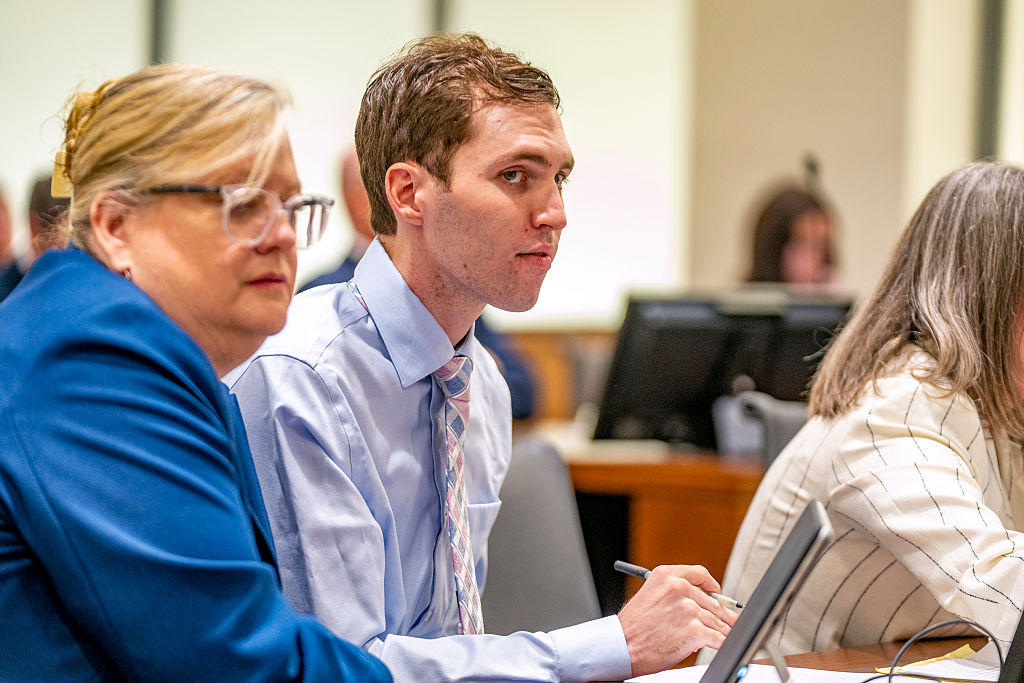 (Rick Egan | The Salt Lake Tribune) Defense attorneys Kathryn Nester, left, and Staci Visser, right, speak with Tyler Robinson during a hearing in Provo's 4th District Court on Thursday, Dec. 11, 2025. Robinson is accused of fatally shooting Charlie Kirk.