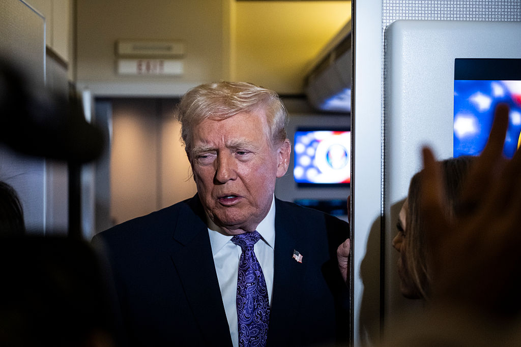 NOVEMBER 30: ABOARD AIR FORCE ONE President Donald Trump speaks to the press aboard Air Force One en-route to Washington, DC on November 30, 2025. The first family is returning to Washington, DC after spending the Thanksgiving holiday weekend at his Mar-A-Lago Resort In Florida.  (Photo by Pete Marovich/Getty Images)