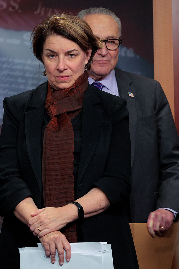 WASHINGTON, DC - DECEMBER 17: Senate Minority Leader Charles Schumer (D-NY) (R) and Democratic Policy Committee Chair Sen. Amy Klobuchar (D-MN) hold a news conference at the U.S. Capitol on December 17, 2025 in Washington, DC. After criticizing President Donald Trump's economic policies, Senate Democrats unveiled their initiative to lower costs in 2026.  (Photo by Chip Somodevilla/Getty Images)