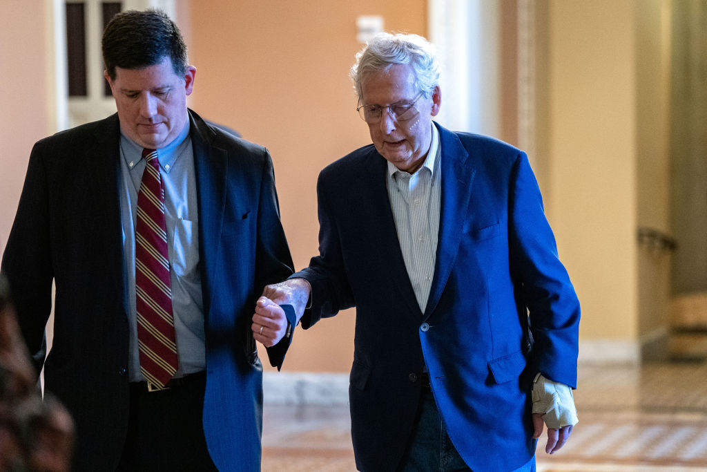WASHINGTON, DC - DECEMBER 11:  U.S. Senate Minority Leader Mitch McConnell (R-KY) is assisted by staff as he goes to the Senate Chamber to vote on December, 11, 2024 in Washington, DC. The Kentucky Republican fell after tripping following attending a lunch, spraining his wrist and sustaining a minor cut to the face according to his office said in a statement. The incident is the latest in a high-profile string of health issues for the 82 year old Senator. (Photo by Kent Nishimura/Getty Images)