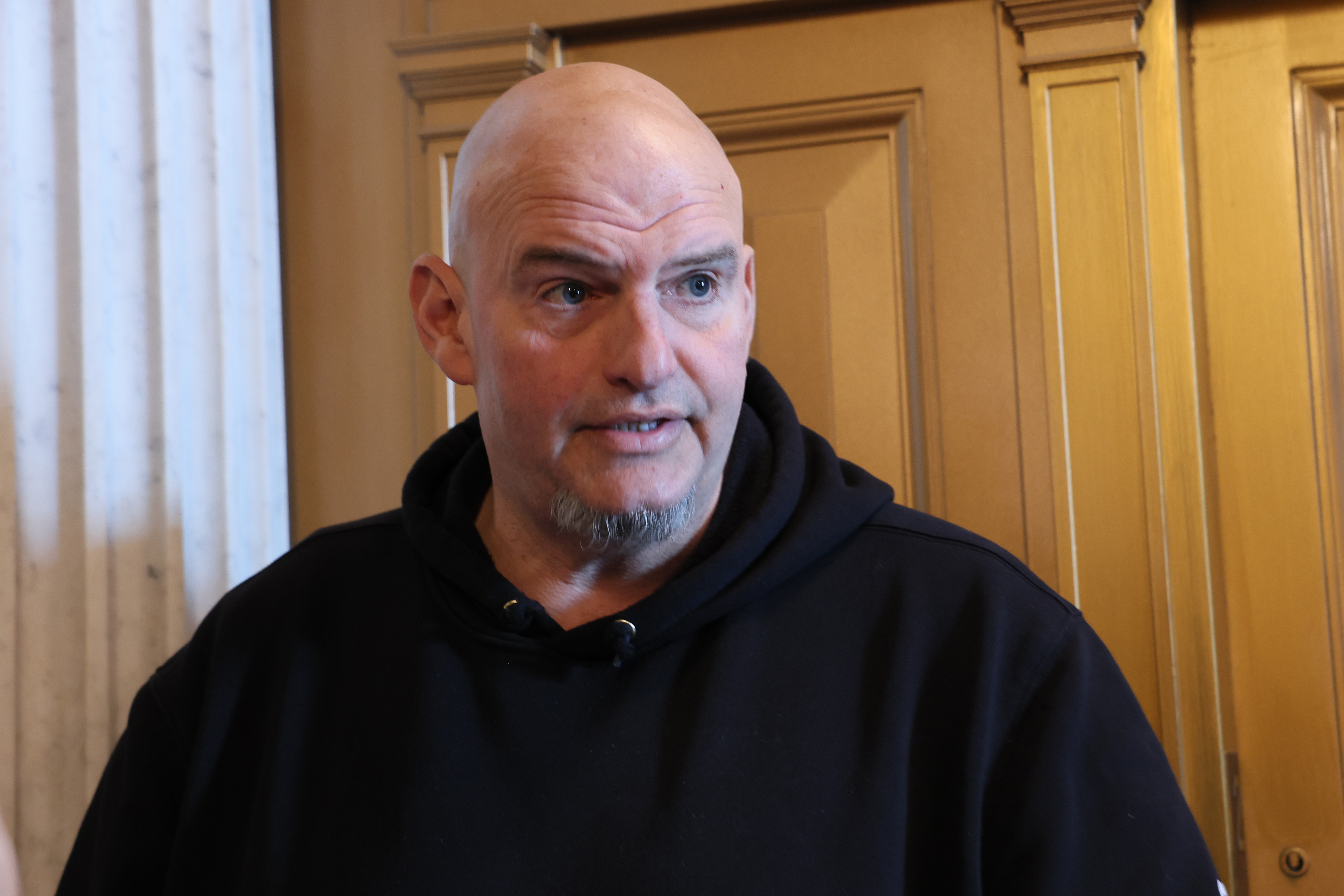 WASHINGTON, DC - FEBRUARY 10: U.S. Sen. John Fetterman (D-PA) speaks with reporters in the halls of the US Capitol on February 10, 2026 in Washington, DC. Congress is facing a Friday deadline to find bipartisan legislation to fund the Department of Homeland Security, right before a Presidents Day recess. (Photo by Michael M. Santiago/Getty Images)
