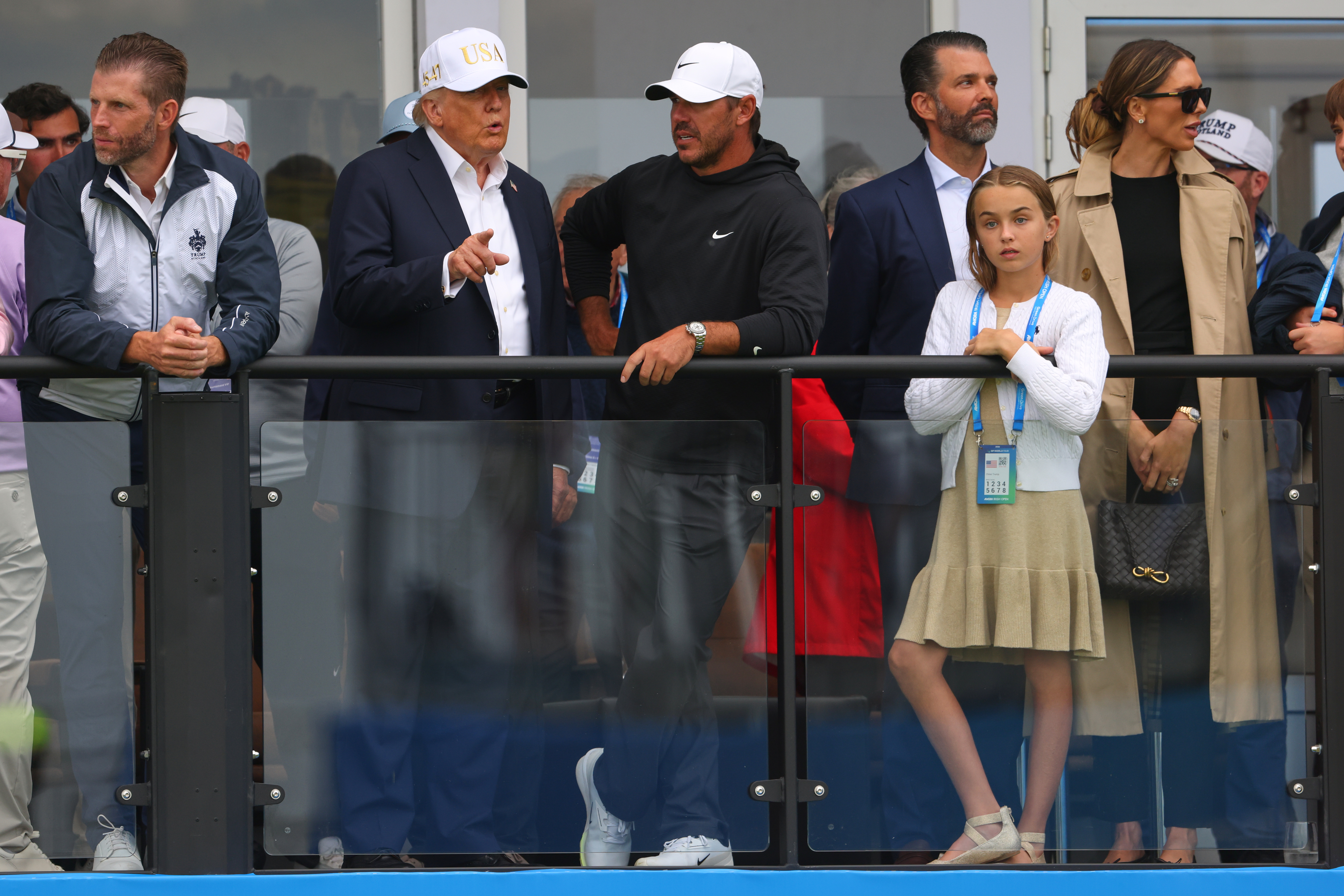 U.S. President Donald Trump chats with US golfer Brooks Koepka at the Irish Open at the Trump International Golf Links course in Doonbeg, Ireland, Saturday, Sept. 12, 2026.(AP Photo/Peter Morrison)