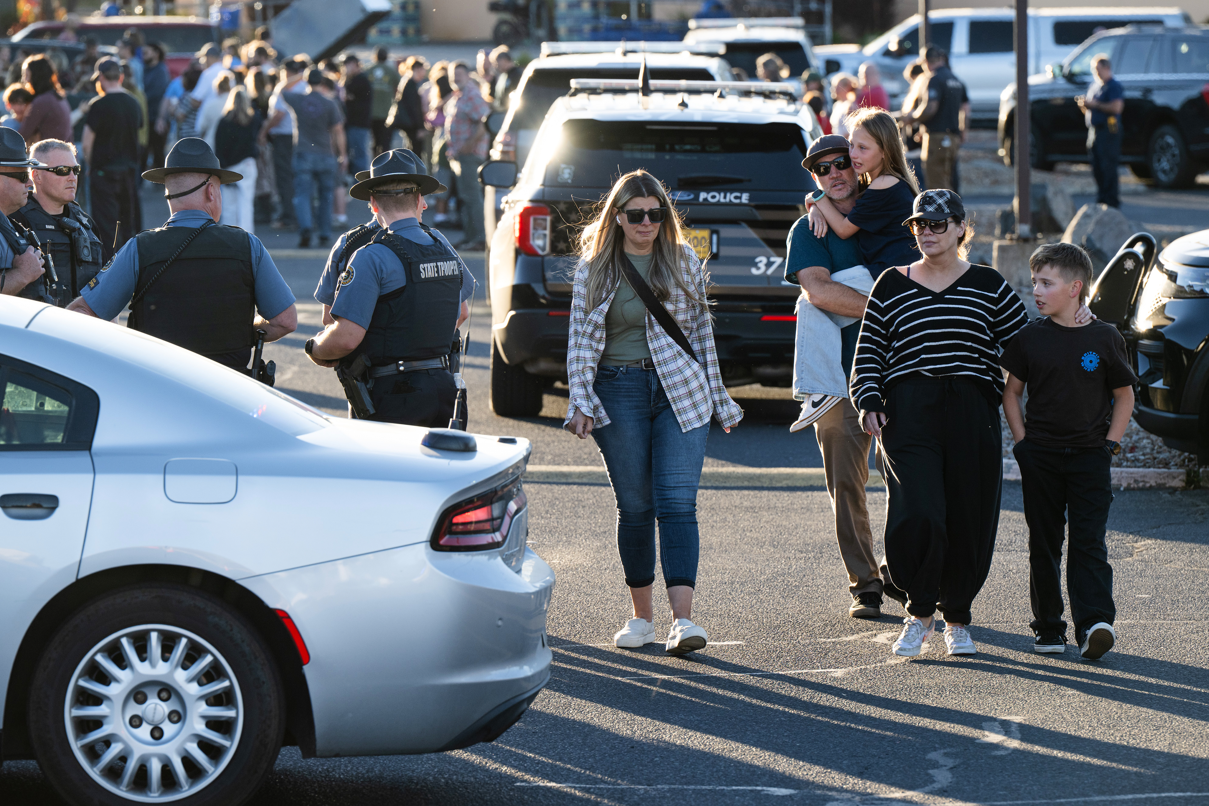 People leave a family meeting area following a shooting at Silver Rail Elementary School, Thursday, Oct. 15, 2026, in Bend, Ore. (AP Photo/Joe Kline)