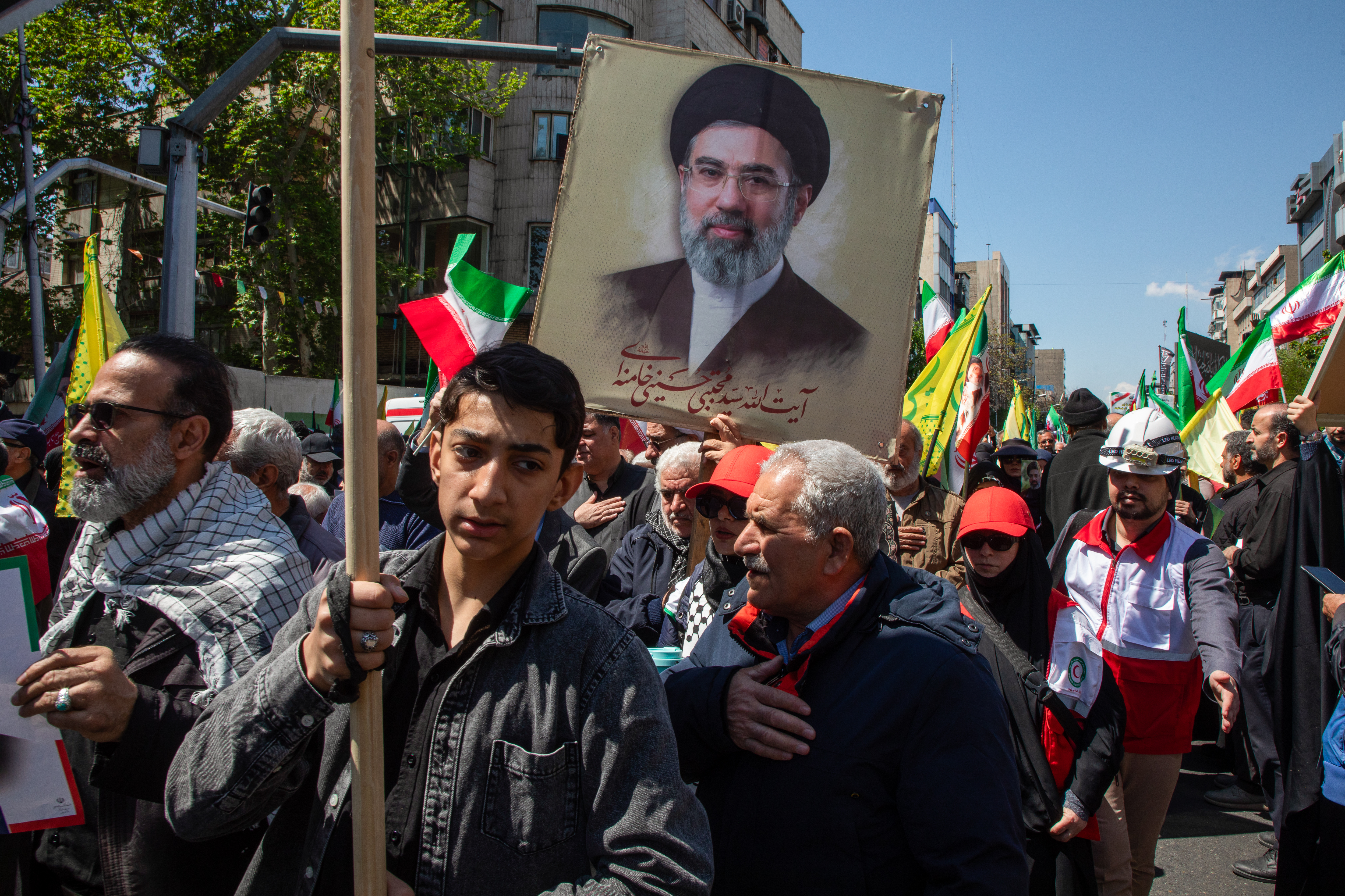 TEHRAN, IRAN - APRIL 9: Iranians carry a portrait of Iran's new Supreme Leader, Mojtaba Khamenei, as they gather during a memorial for Iran's late Supreme Leader Ali Ayatollah Khamenei to mark the 40th day since he was killed in US-Israeli joint strikes, on April 9, 2026 in Tehran, Iran. On April 8 President Donald Trump announced a two-week ceasefire between the US and Iran, conditional on shipping being allowed to resume through the Strait of Hormuz. (Photo by Majid Saeedi/Getty Images)
