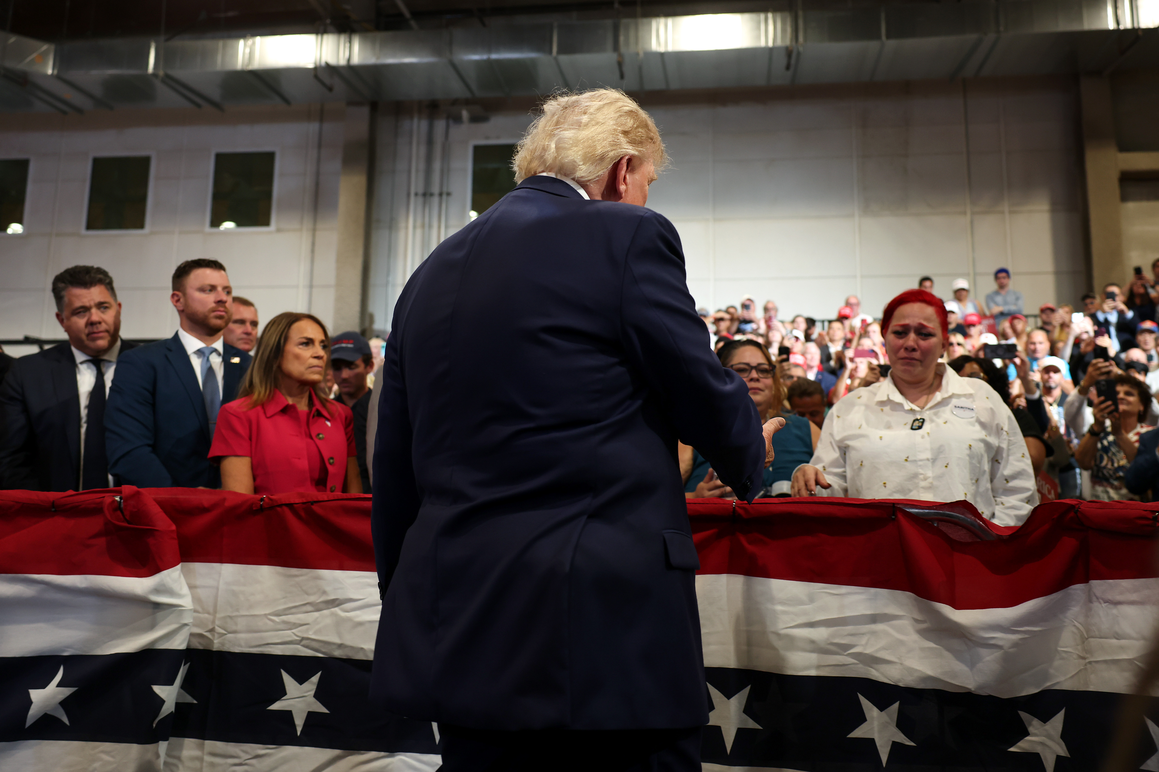 GARDEN CITY, NEW YORK - AUGUST 14: U.S. President Donald Trump greets Migdalia Martinez (R), whose 12-year-old son Jacob Freytas was killed by a stray bullet, during an event at the David S. Mack Center for Training and Intelligence on August 14, 2026 in Garden City, New York. President Trump visited the police academy to highlight the FBI's 2025 Crime Statistics Report and rally support for local Republican candidates ahead of the upcoming midterm elections. (Photo by Samuel Corum/Getty Images)