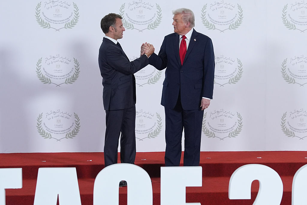 President Donald Trump greets France's President Emmanuel Macron during summit to support ending the more than two-year Israel-Hamas war in Gaza after a breakthrough ceasefire deal, Monday, Oct. 13, 2025, in Sharm El Sheikh, Egypt. (AP Photo/Evan Vucci, Pool)