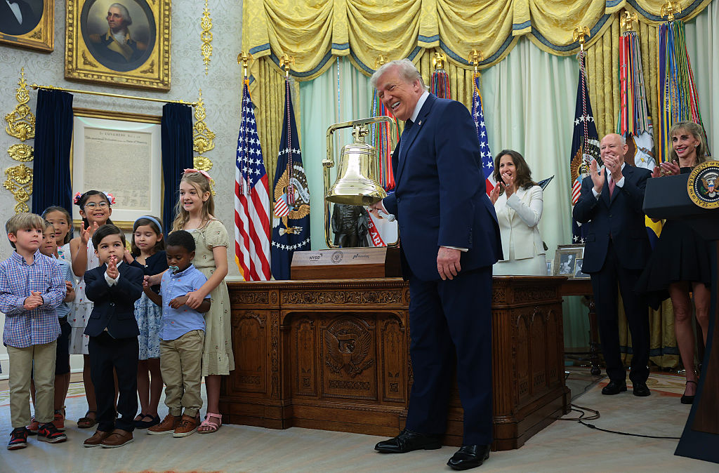 WASHINGTON, DC - JULY 06: U.S. President Donald Trump rings a bell to mark the first day of trading for