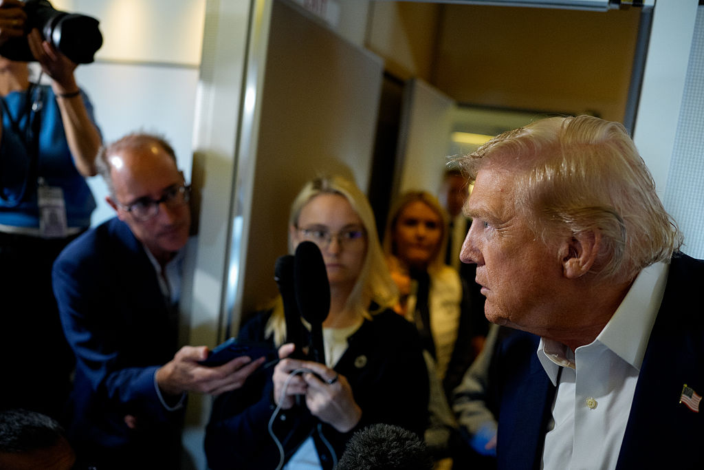 IN FLIGHT - JULY 29: U.S. President Donald Trump takes a question from a reporter aboard Air Force One on July 29, 2025 in flight. President Trump is returning from a trip to  Scotland that was part vacation, part work, as he stayed at his Trump Turnberry golf course, followed by Trump International Golf Links in Aberdeenshire, from July 25 to 29. (Photo by Andrew Harnik/Getty Images)