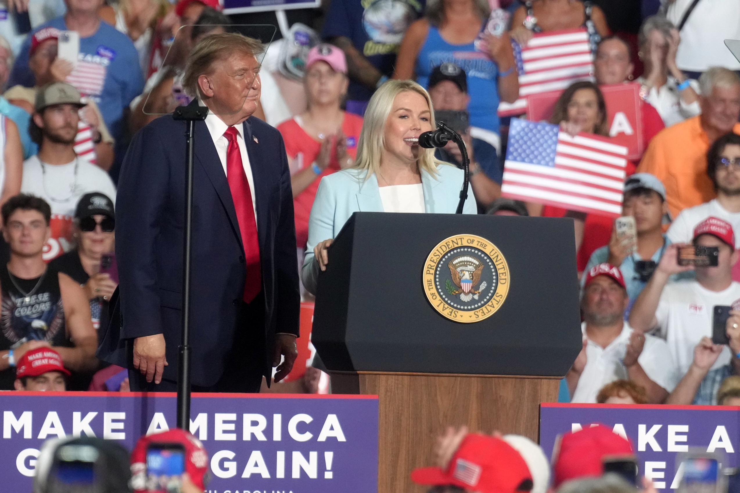 President Donald Trump looks on as outgoing White House press secretary Karoline Leavitt speaks at a campaign rally for Sen. Darline Graham. R-S.C., as she competes in a special Republican primary to replace her brother, the late Sen. Lindsey Graham, R-S.C., Friday, Aug. 21, 2026, in Myrtle Beach, S.C. (AP Photo/Meg Kinnard)