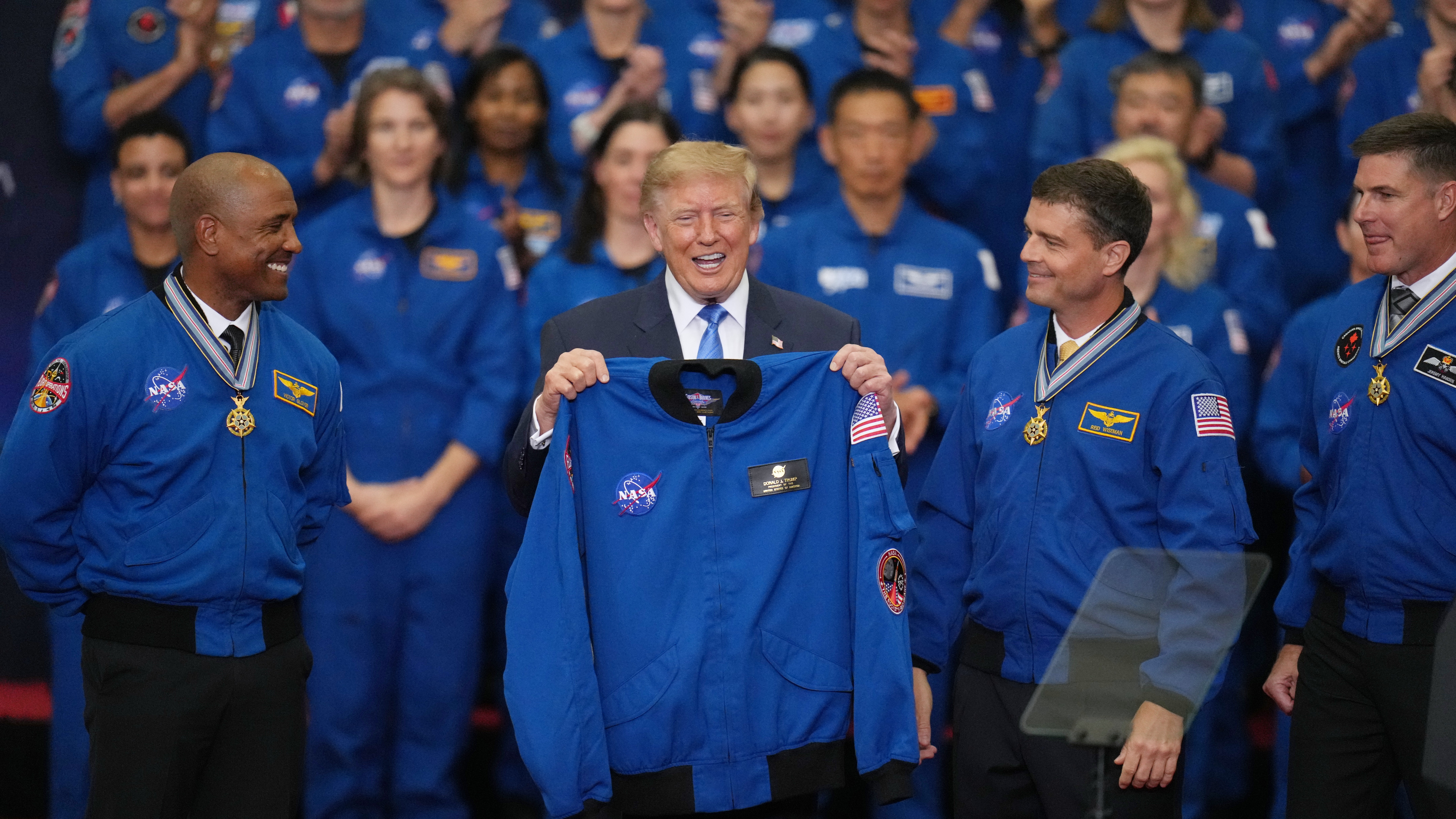 President Donald Trump participates in a Congressional Space Medal of Honor ceremony at NASA's Johnson Space Center, Friday, Aug. 28, 2026, in Houston, with Artemis II Astronauts from left, Pilot Victor Glover, Commander Reid Wiseman and Mission Specialist Jeremy Hansen. (AP Photo/Karen Warren)
