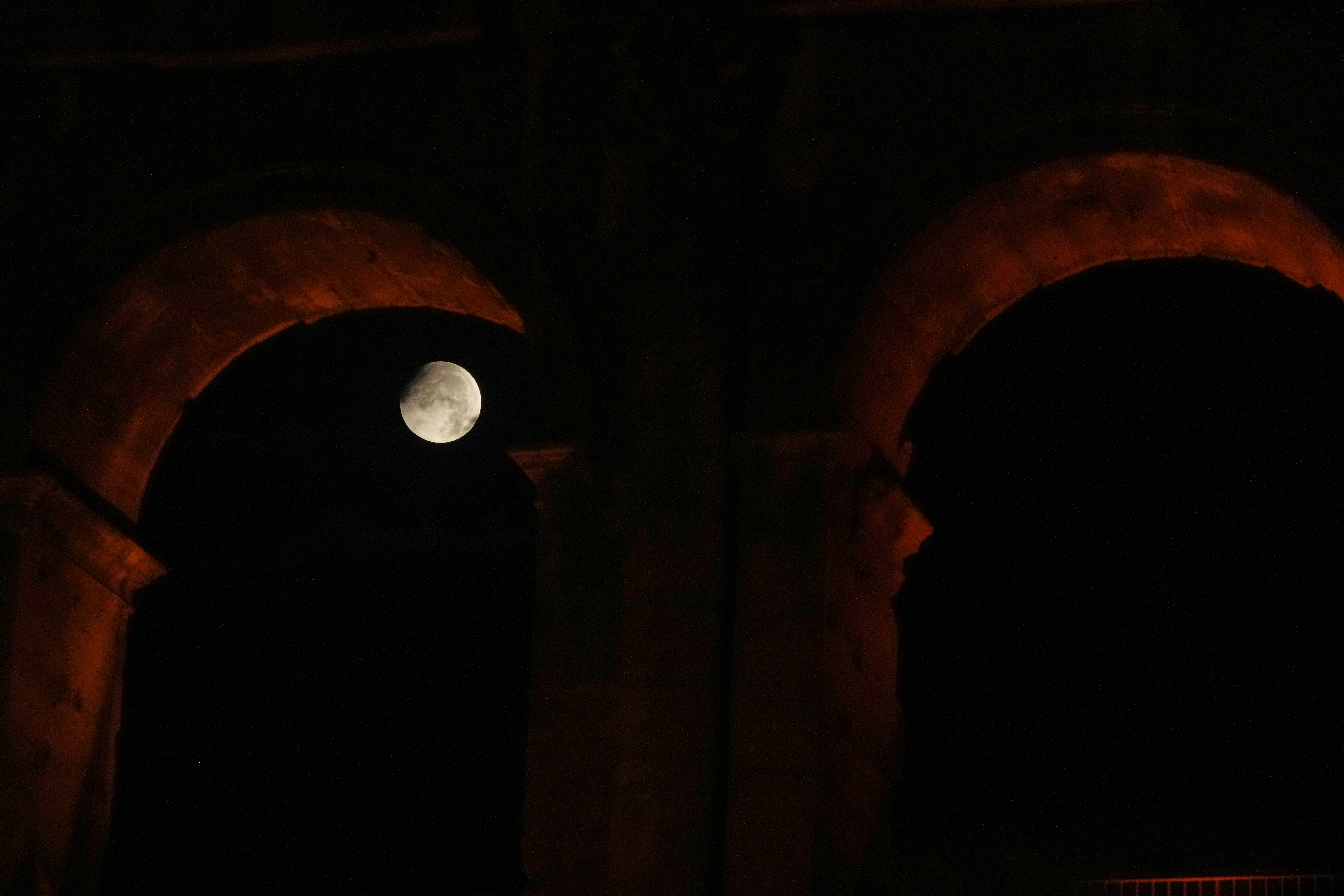 The moon sets behind the Colosseum during a partial lunar eclipse in Rome, Friday, Aug. 28, 2026. (AP Photo/Gregorio Borgia)