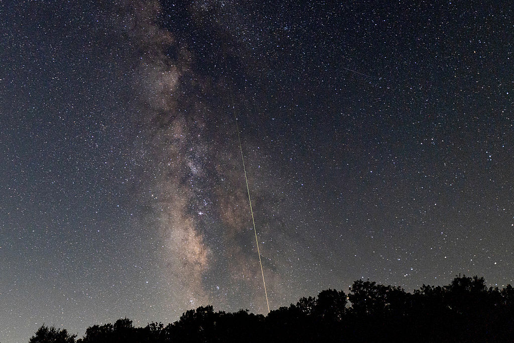 A meteor streaks across the sky during the Perseid meteor shower peak at Pedernales Falls State Park on August 12, 2026 in Johnson City, Texas. (Image Source: Rick Kern/Getty Images)