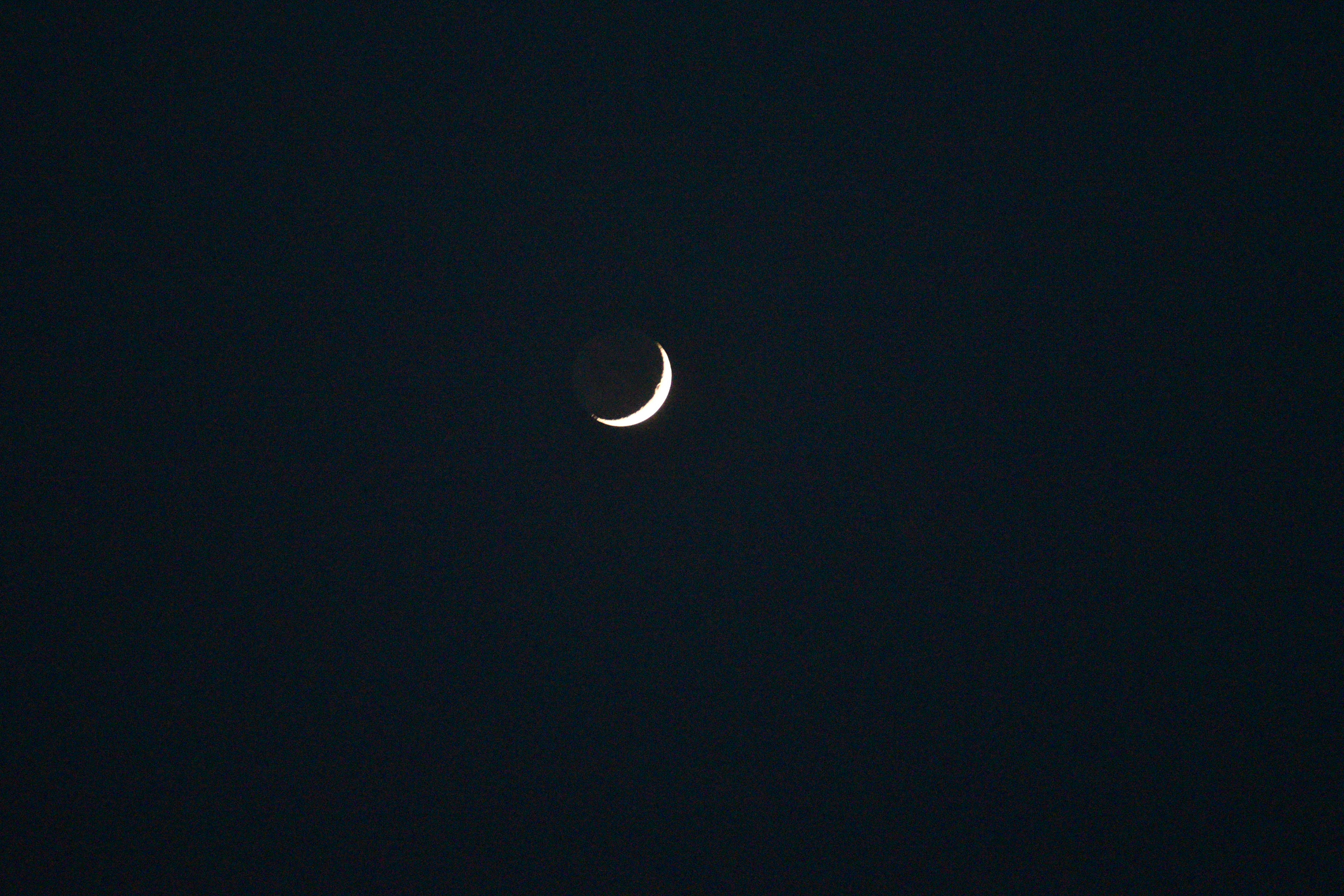 The image captures a bright crescent of the Moon in its waxing phase. This phase follows immediately after the New Moon phase.