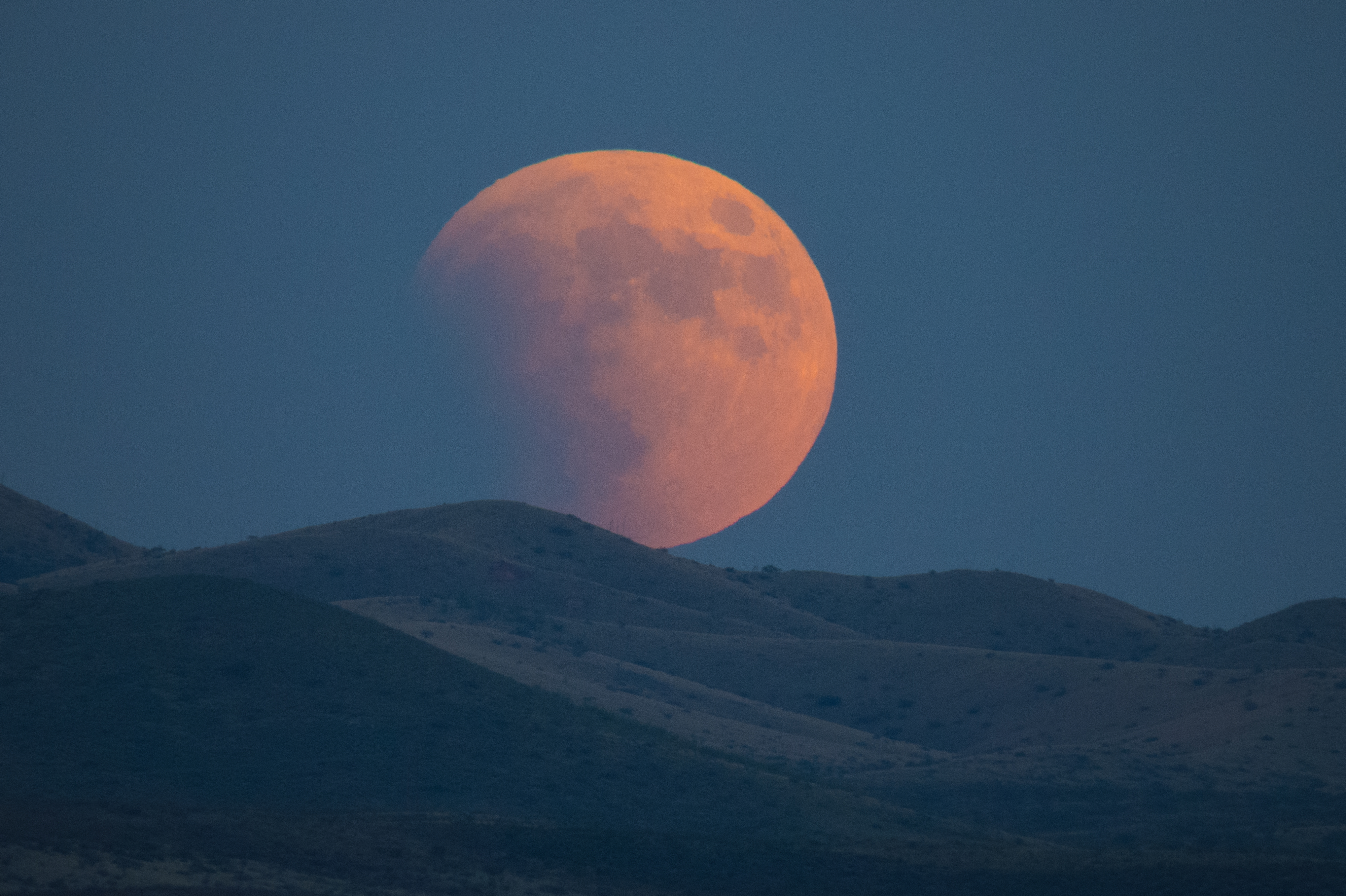 Super-blood moon rises over the Dragoon Mountains as viewed from Tombstone, Arizona