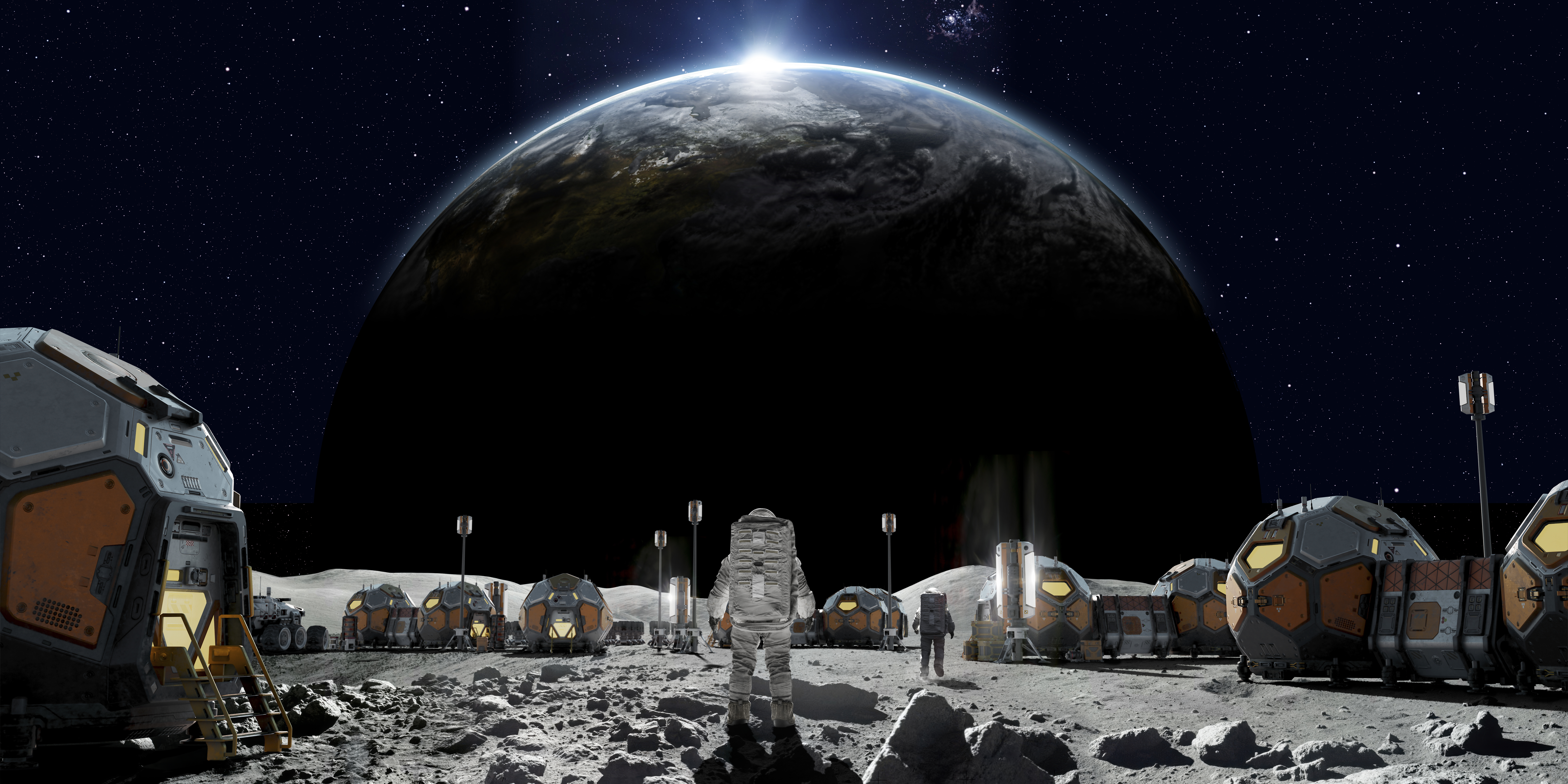 Rear view of an astronaut near some foreground rocks walking into their lunar base camp made from group of linked habitation pods, solar panels and equipment. With dramatic sunrise over earth.