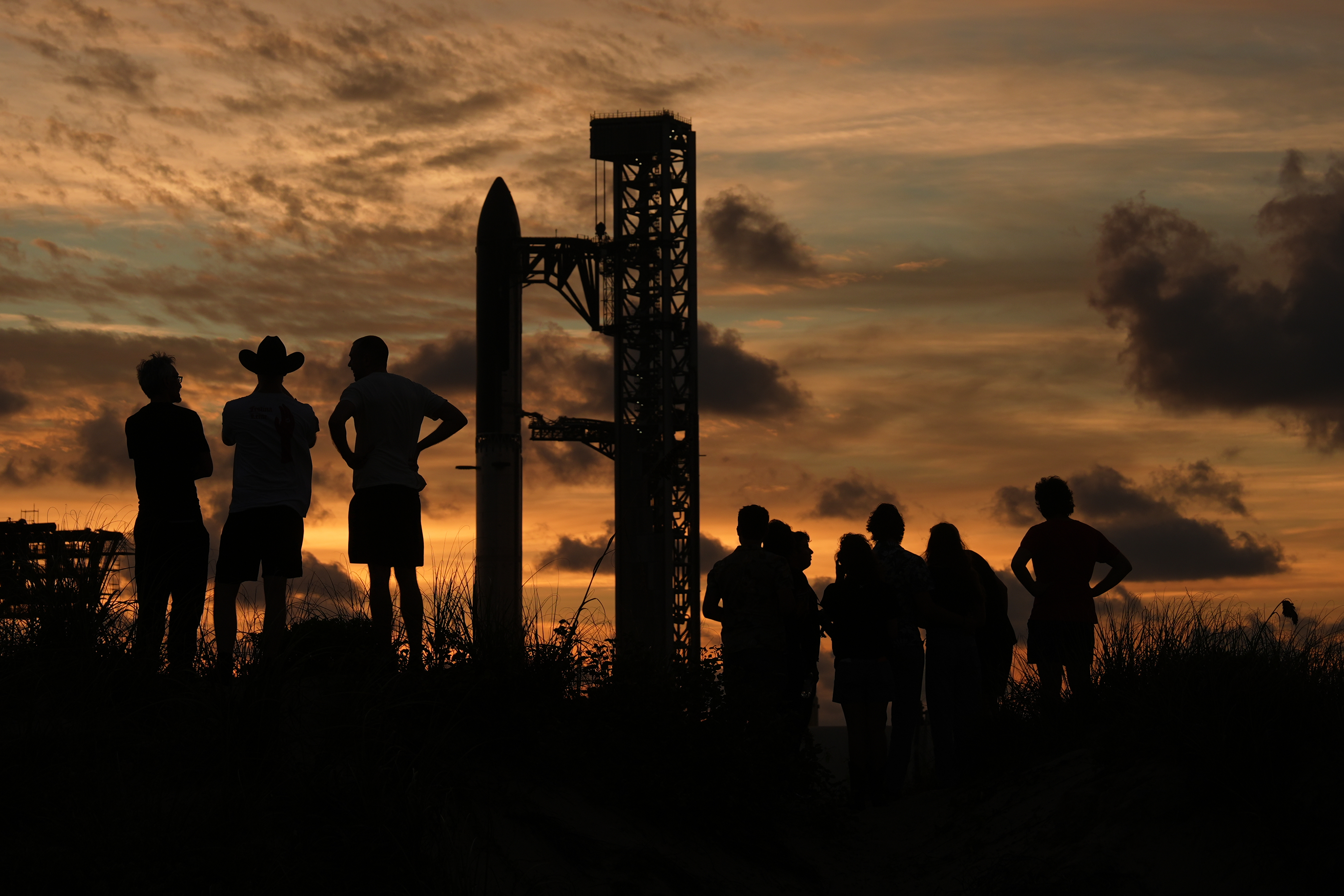 People gather at sunset as Starship is prepared for Flight 14 from Starbase, Texas. (Image Source: AP Photo | Eric Gay)