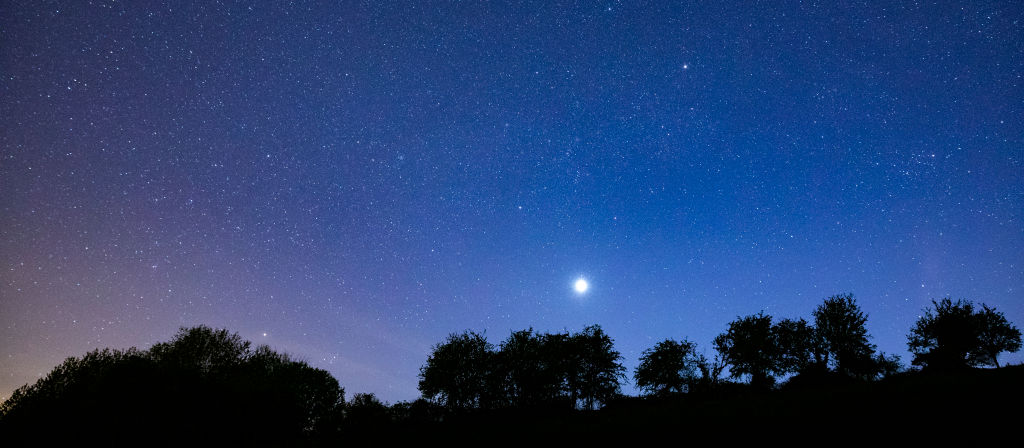 THE COTSWOLDS, UNITED KINGDOM: Multitude of stars and a shooting star in night sky with Venus at its brightest stage this year in prominent view over southern England, United Kingdom.  (Photo by Tim Graham/Getty Images)