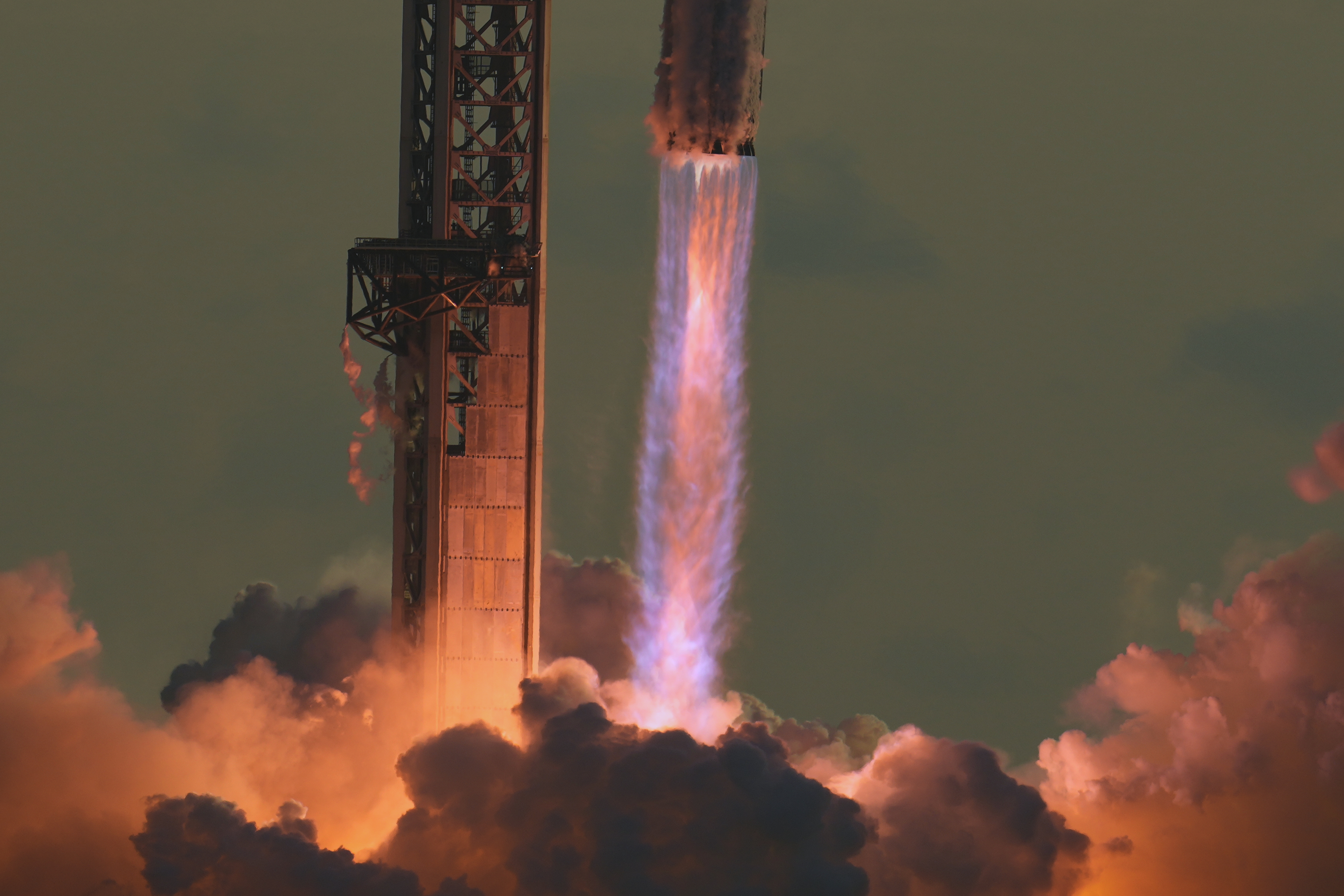 Exhaust from Merlin engines visible as Starship lifts off for a test flight from Starbase, Texas. (Image Source: AP Photo | Eric Gay)