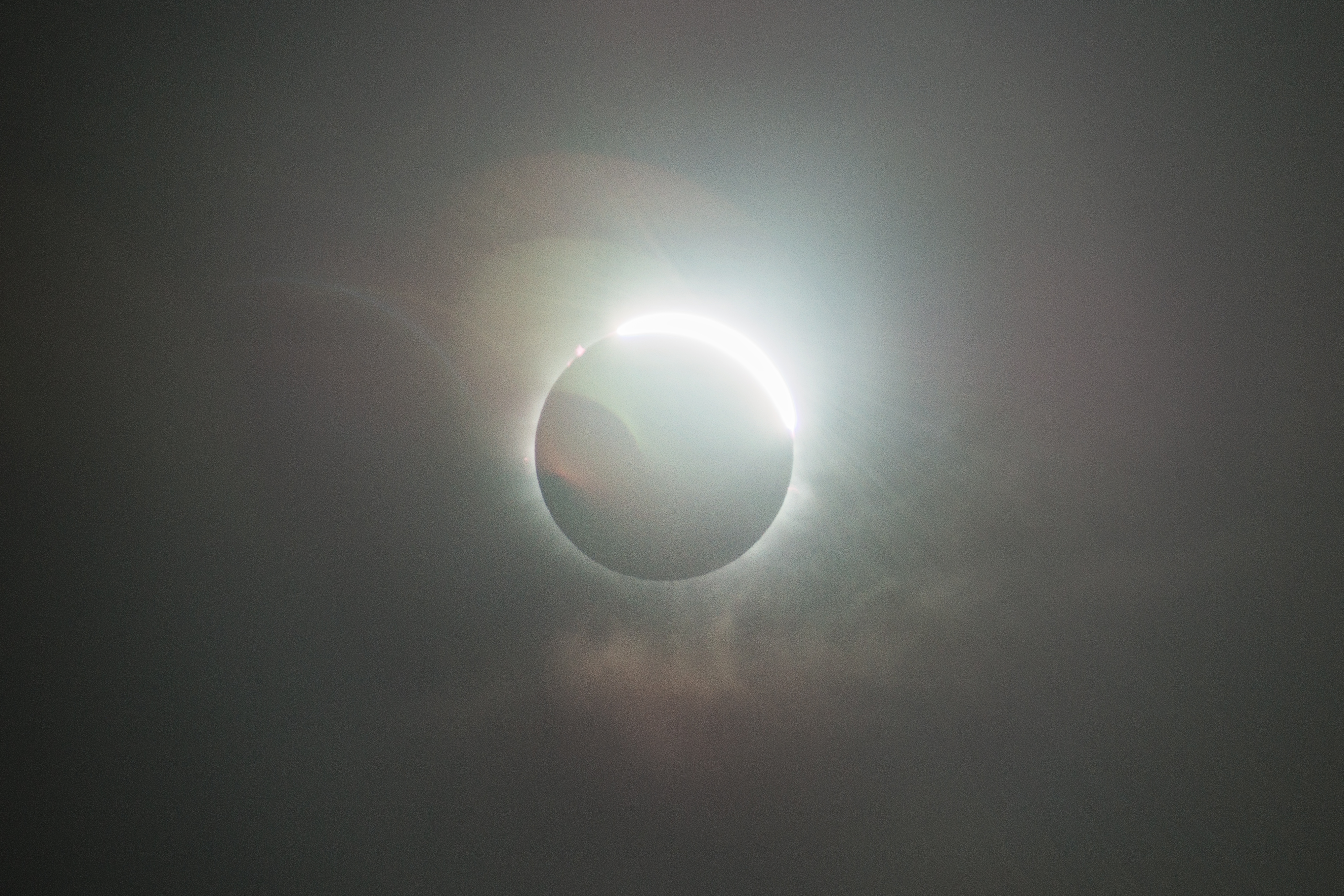 A solar eclipse occurs when the Moon passes between Earth and the Sun, thereby totally or partly obscuring the image of the Sun for a viewer on Earth. A total solar eclipse occurs when the Moon's apparent diameter is larger than the Sun's, blocking all direct sunlight, turning day into darkness. Totality occurs in a narrow path across Earth's surface, with a partial solar eclipse visible over a surrounding region thousands of kilometres wide.