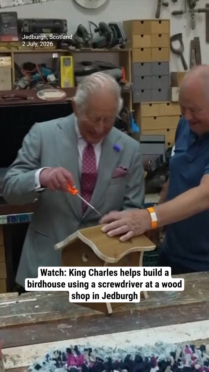 Watch: King Charles helps build a birdhouse using a screwdriver at a wood shop in Jedburgh