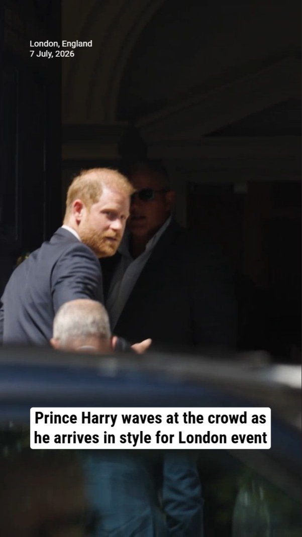 Prince Harry waves at the crowd as he arrives in style for London event