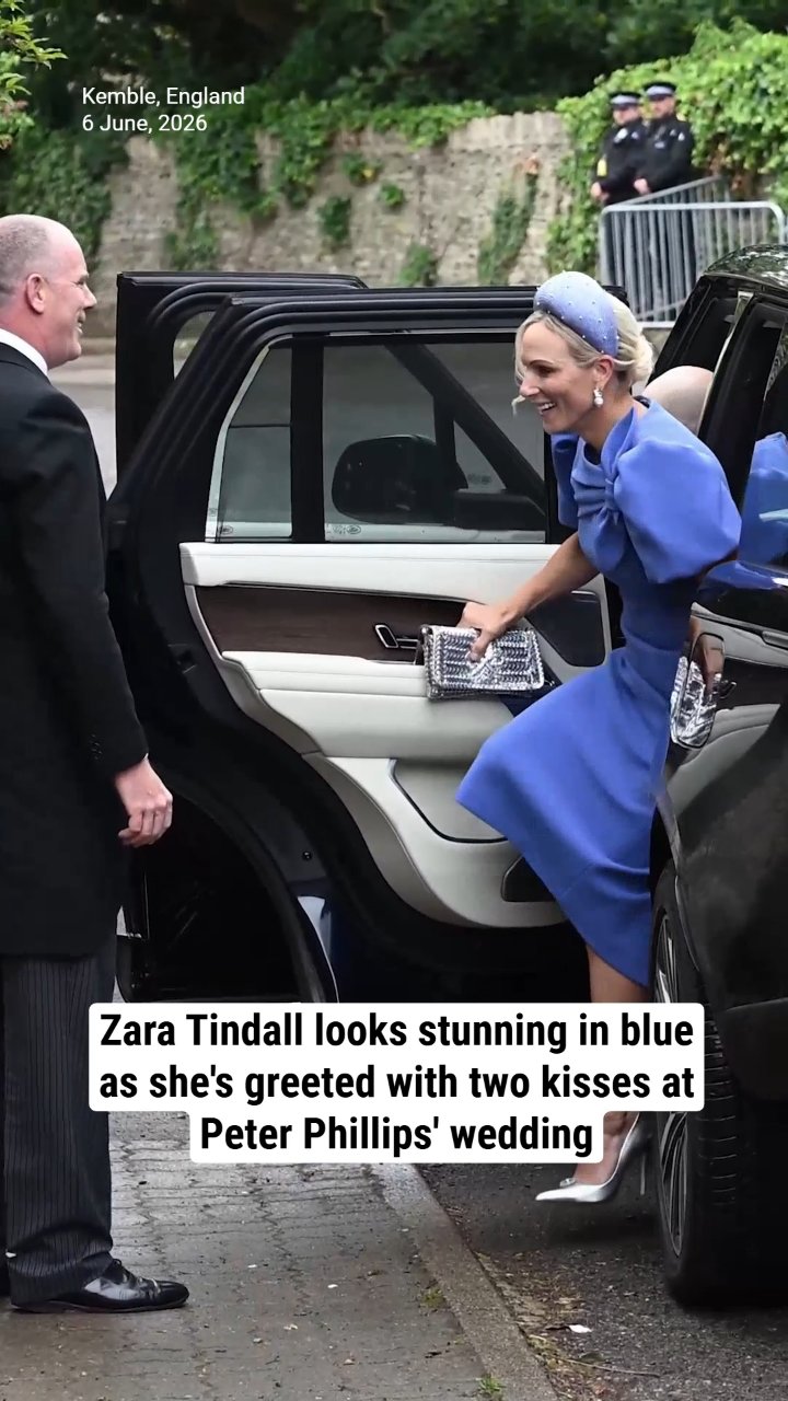 Zara Tindall looks stunning in blue as she's greeted with two kisses at Peter Phillips' wedding