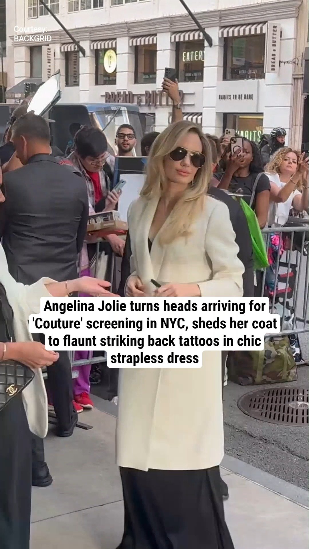 Angelina Jolie turns heads arriving for 'Couture' screening in NYC, sheds her coat to flaunt striking back tattoos in chic strapless dress