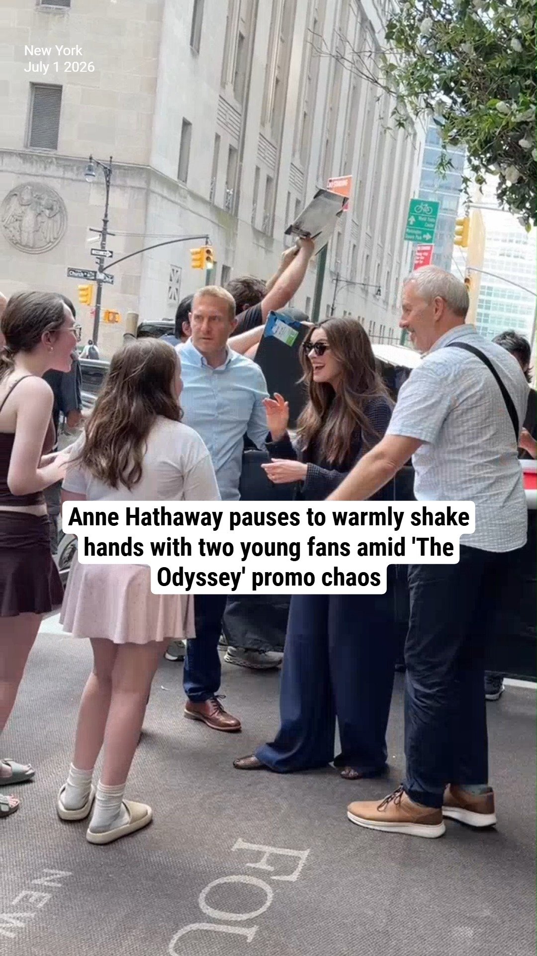 Anne Hathaway pauses to warmly shake hands with two young fans amid 'The Odyssey' promo chaos