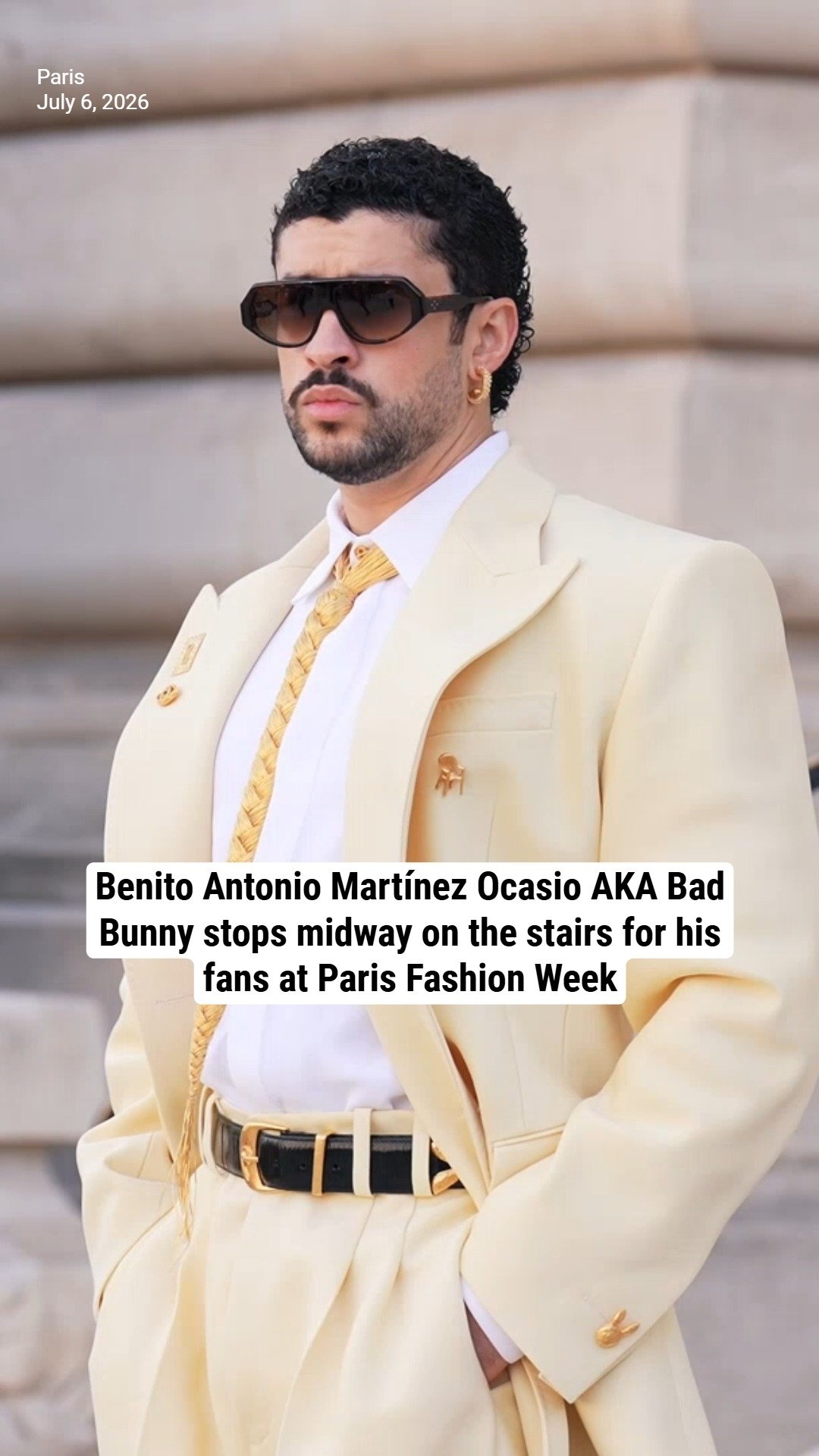 Benito Antonio Martínez Ocasio AKA Bad Bunny stops midway on the stairs for his fans at Paris Fashion Week