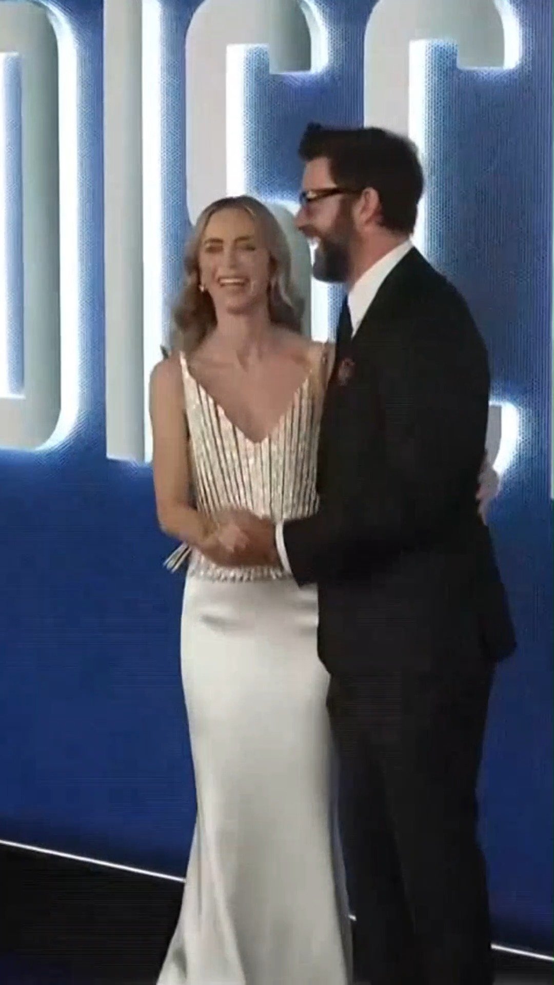 Emily Blunt reaches out for husband John Krasinski's hand with bright smiles at the 'Disclosure Day' New York premiere