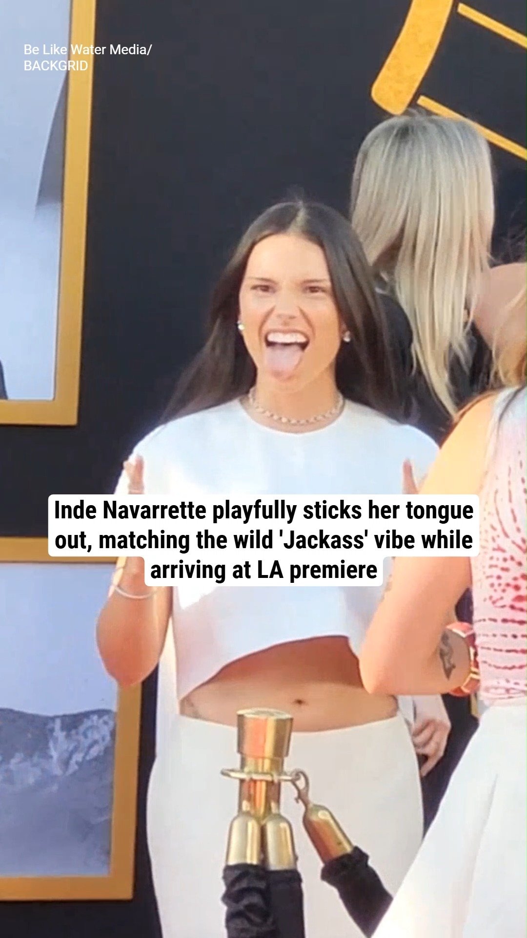 Inde Navarrette playfully sticks her tongue out, matching the wild 'Jackass' vibe while arriving at LA premiere
