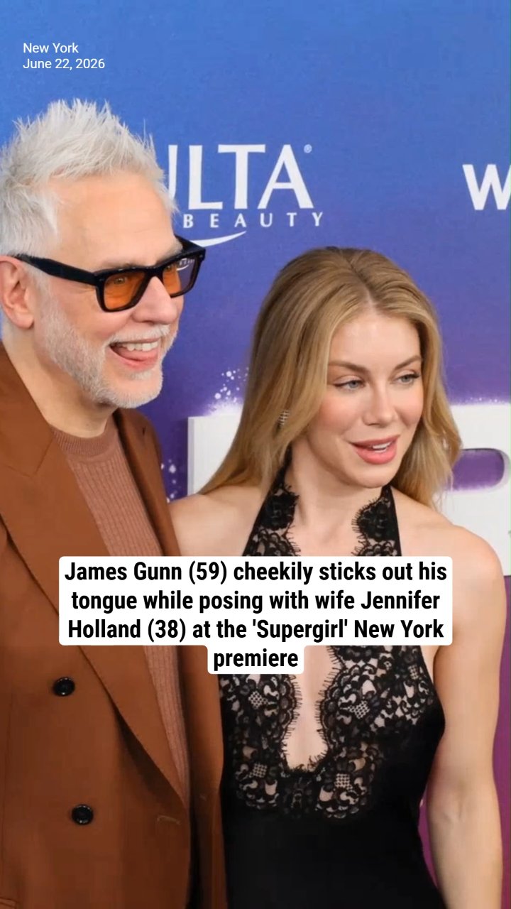 James Gunn (59) cheekily sticks out his tongue while posing with wife Jennifer Holland (38) at the 'Supergirl' New York premiere
