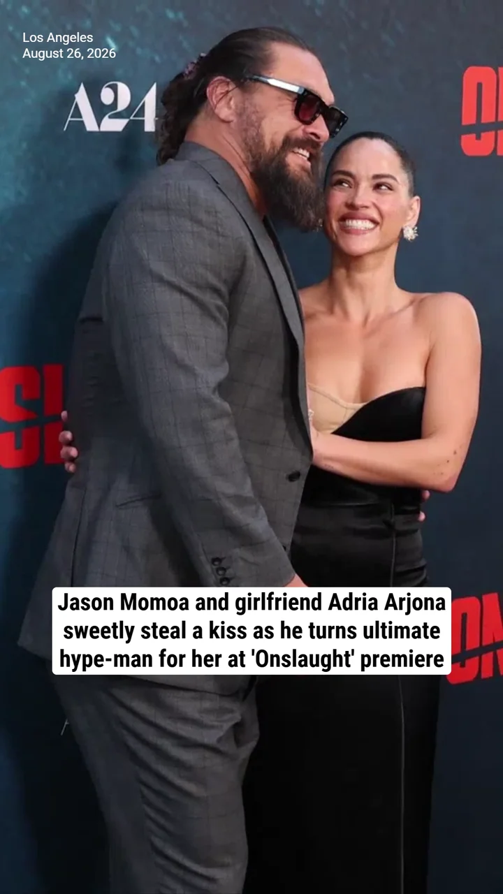 Jason Momoa and girlfriend Adria Arjona sweetly steal a kiss as he turns ultimate hype-man for her at 'Onslaught' premiere
