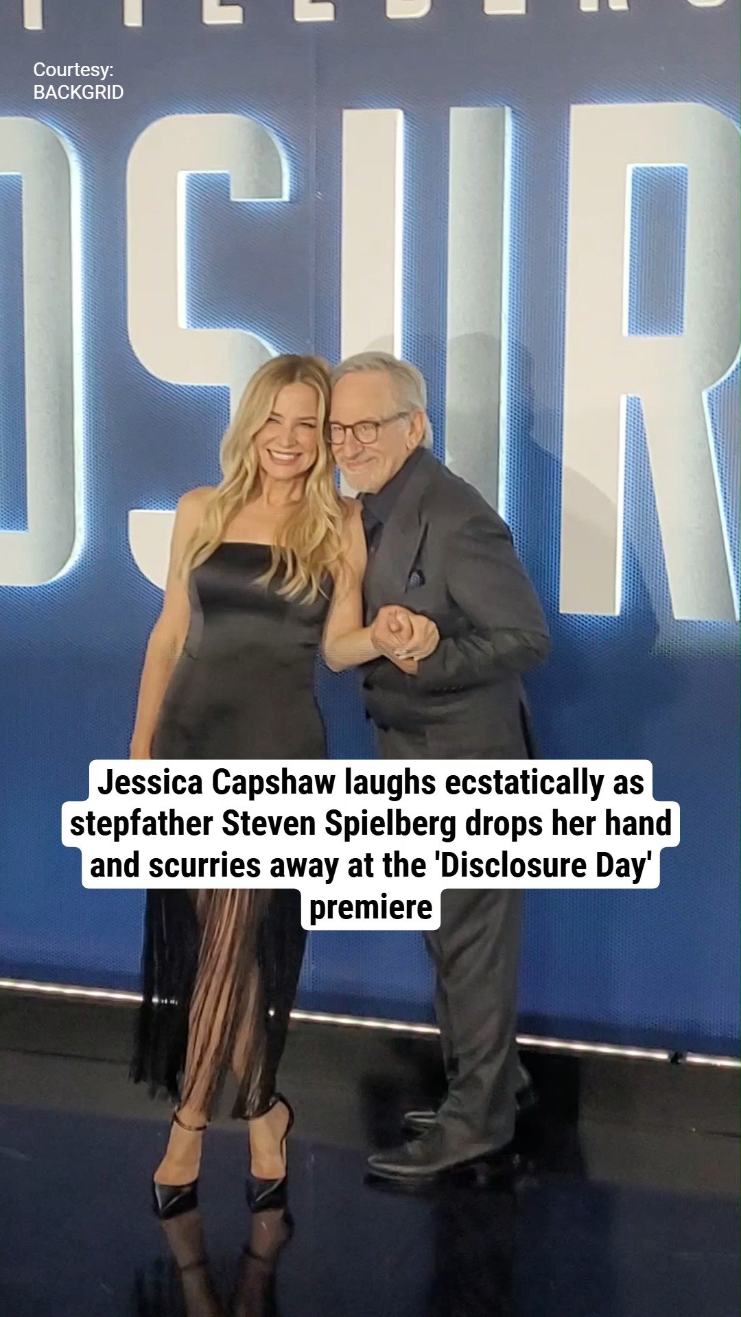 Jessica Capshaw laughs ecstatically as stepfather Steven Spielberg drops her hand and scurries away at the 'Disclosure Day' premiere