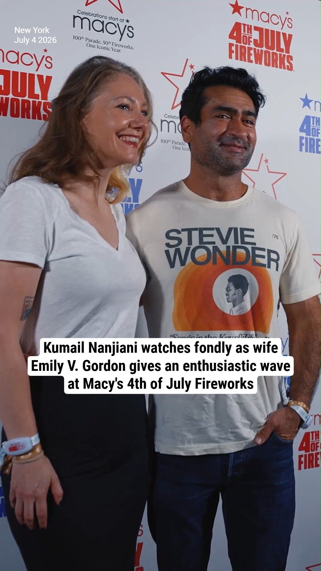 Kumail Nanjiani watches fondly as wife Emily V. Gordon gives an enthusiastic wave at Macy's 4th of July Fireworks