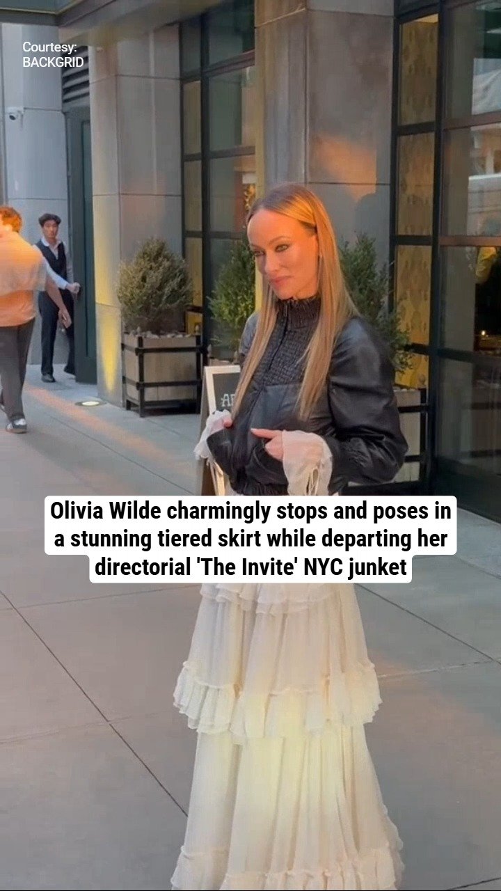 Olivia Wilde charmingly stops and poses in a stunning tiered skirt while departing her directorial 'The Invite' NYC junket