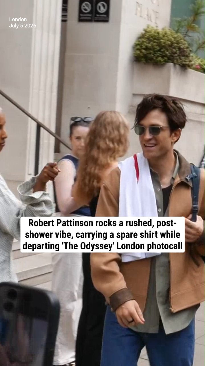 Robert Pattinson rocks a rushed, post-shower vibe, carrying a spare shirt while departing 'The Odyssey' London photocall