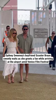 Sydney Sweeney's boyfriend Scooter Braun sweetly waits as she greets a fan while arriving at the airport amid Venice Film Festival