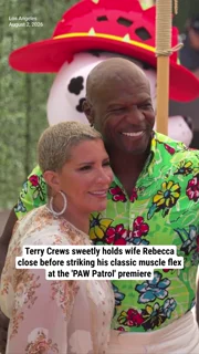 Terry Crews sweetly holds wife Rebecca close before striking his classic muscle flex at the 'PAW Patrol' premiere