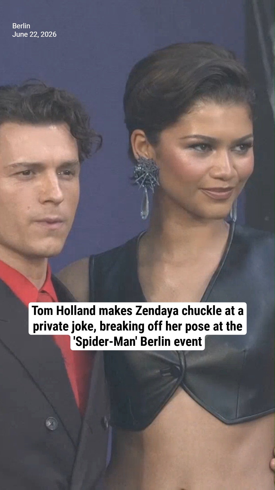 Tom Holland makes Zendaya chuckle at a private joke, breaking off her pose at the 'Spider-Man' Berlin event
